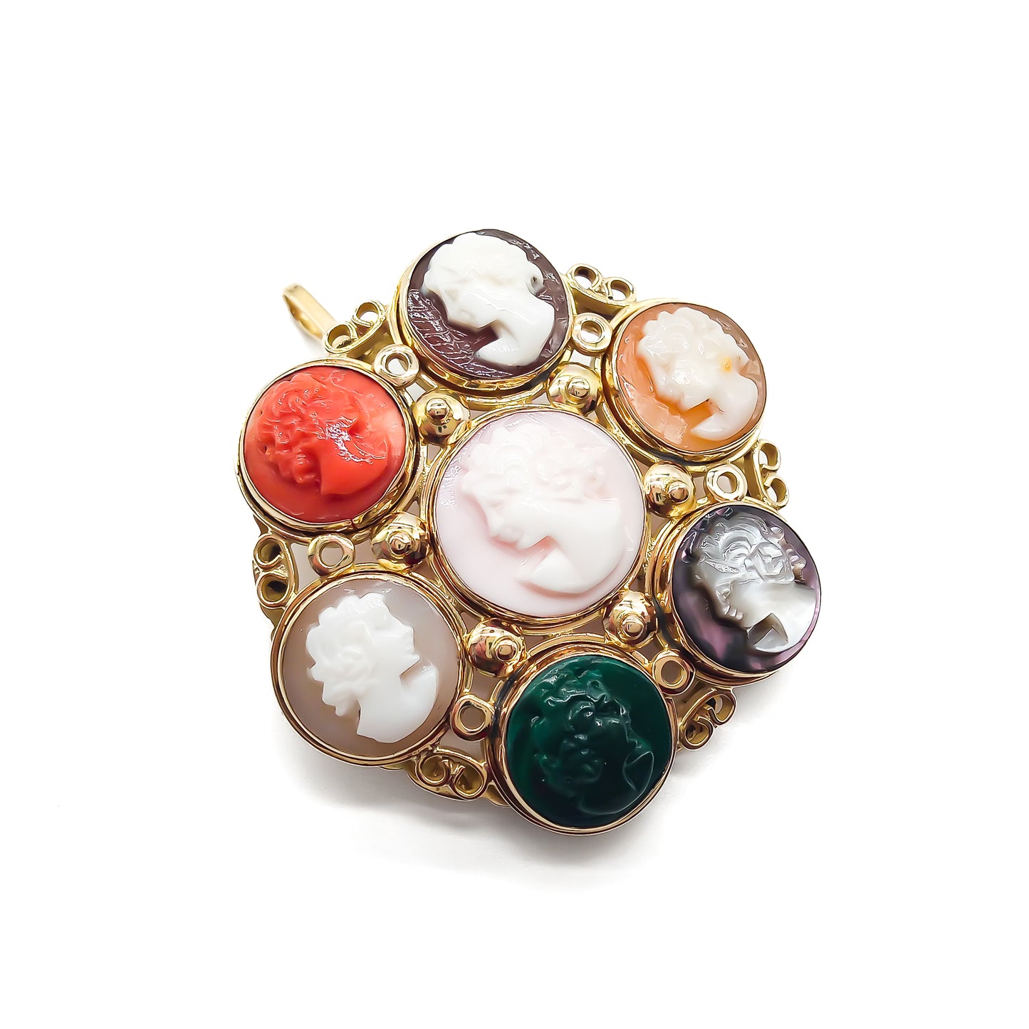 Unique 14ct yellow gold pendant/brooch set with a variety of seven small cameos, including one coral and one chrysoprase. Beautiful scroll work on setting.