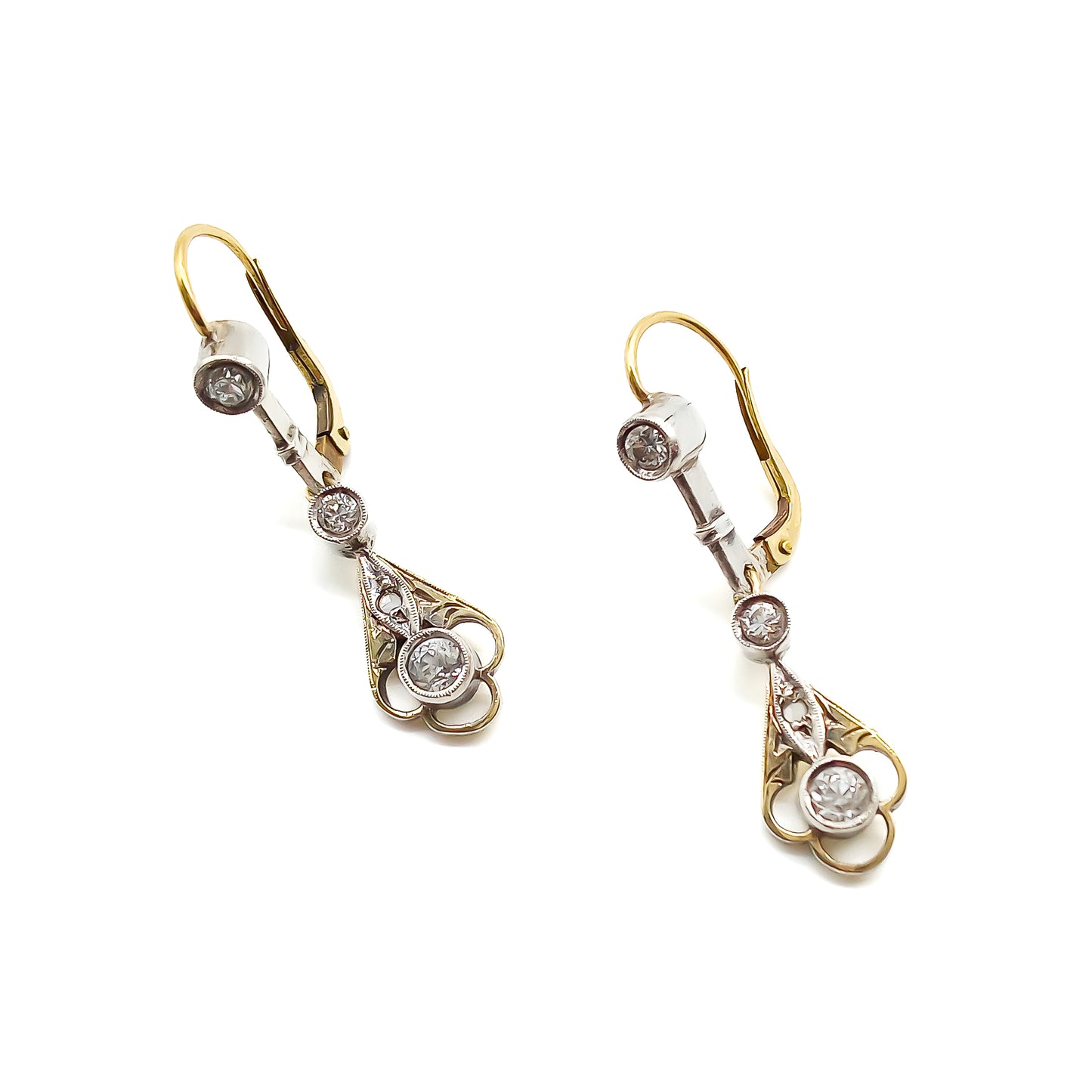 Elegant 14ct white and yellow gold drop earrings, each set with four old-cut diamonds. Circa 1900’s