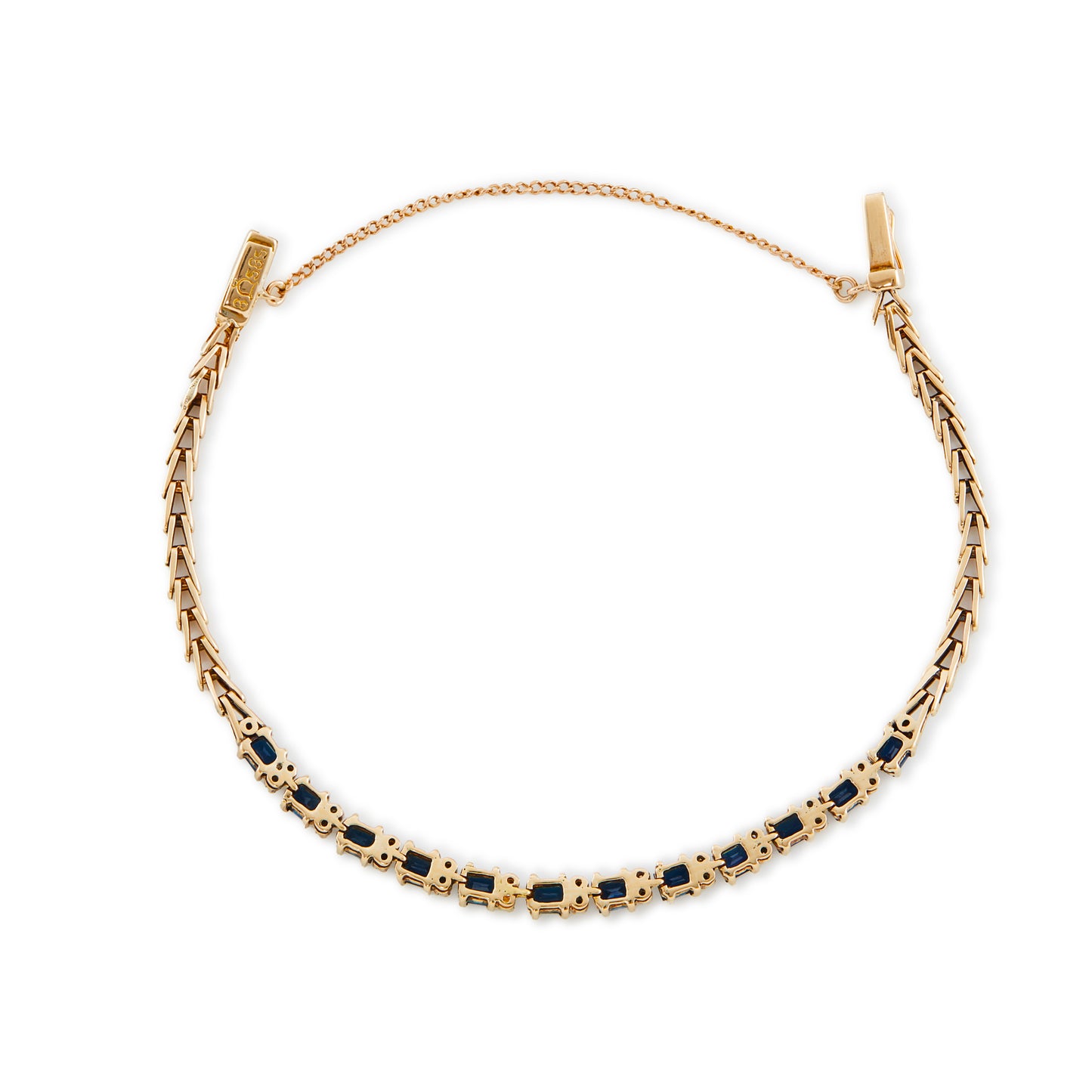 Classic 14ct gold tennis bracelet, set with twelve deep blue rectangular sapphires and twenty-four small diamonds.