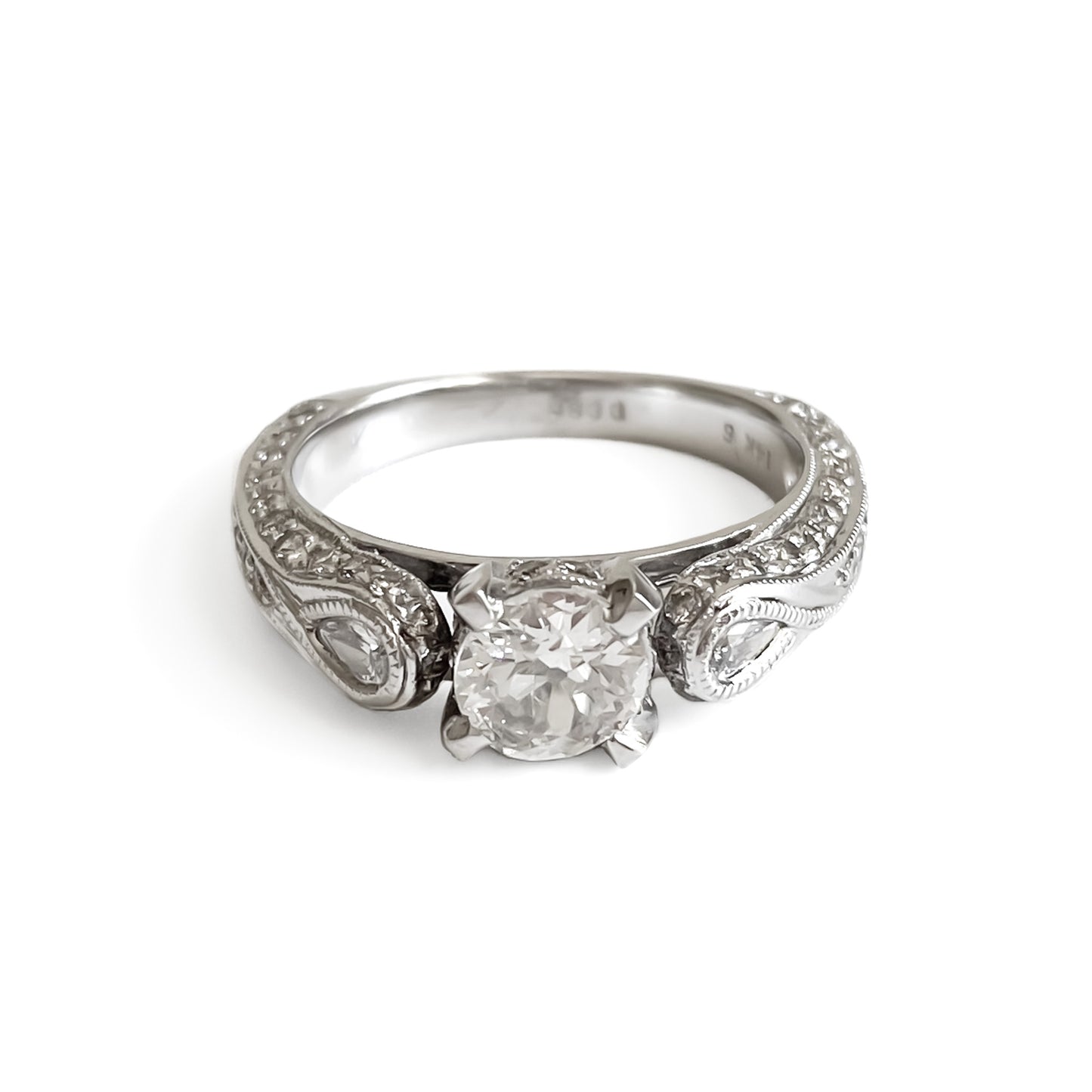 Glamorous 14ct white gold ring set with a 0.66ct centre diamond, a pear-shaped diamond on each shoulder and small pavé set diamonds on the shank. This is a lovely statement piece.  New York