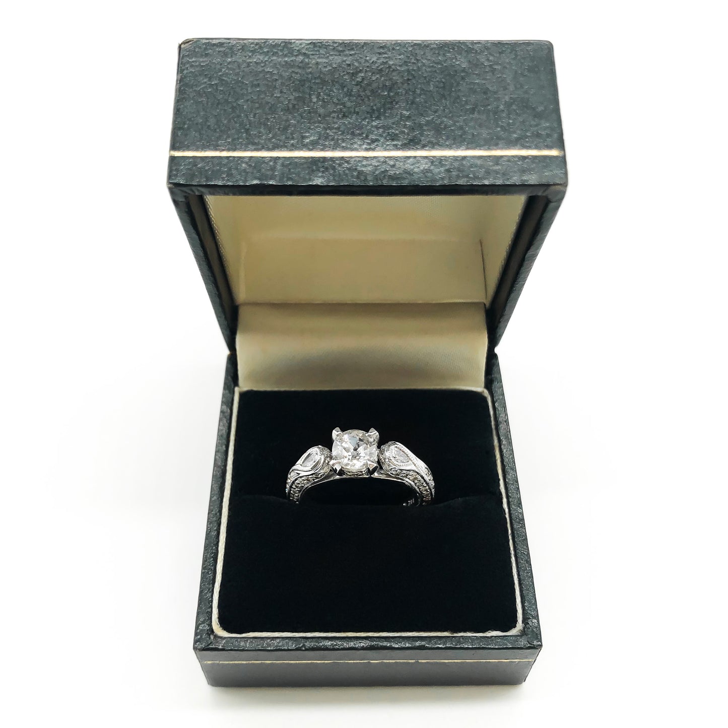 Glamorous 14ct white gold ring set with a 0.66ct centre diamond, a pear-shaped diamond on each shoulder and small pavé set diamonds on the shank. This is a lovely statement piece. New York