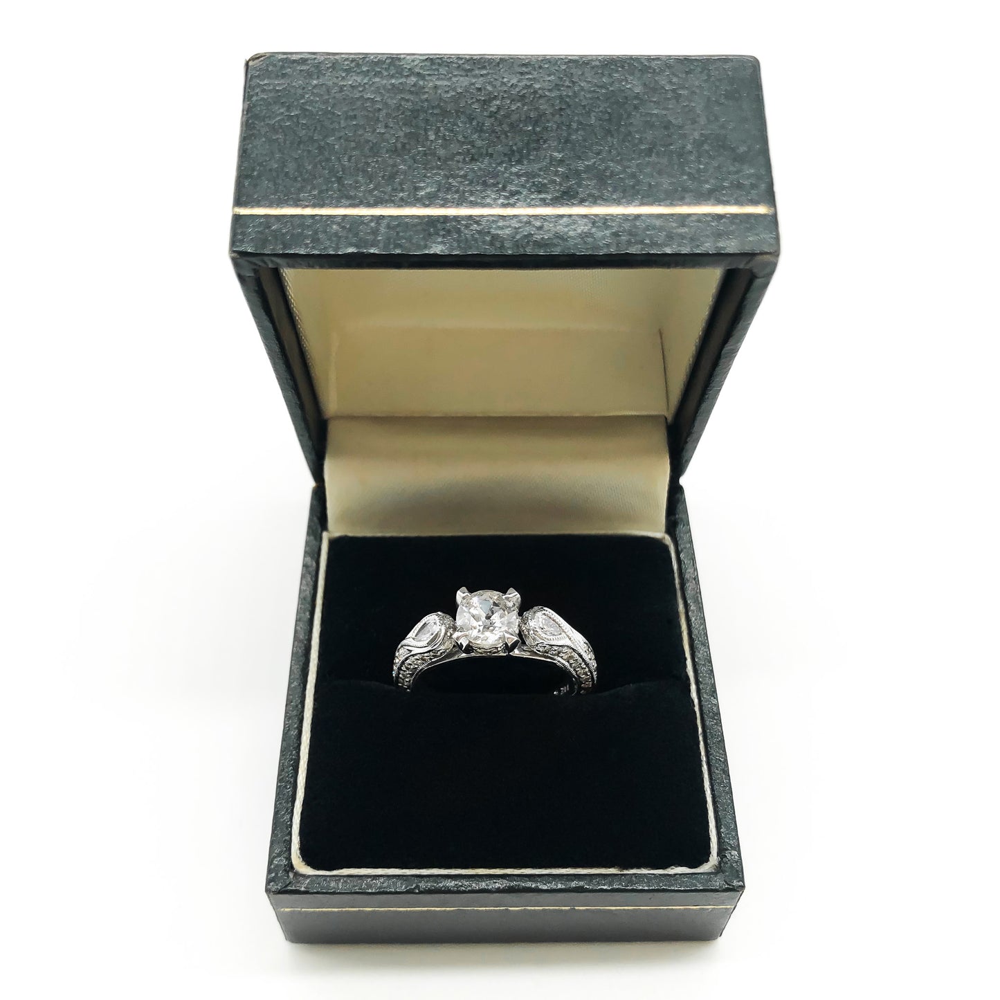 Glamorous 14ct white gold ring set with a 0.66ct centre diamond, a pear-shaped diamond on each shoulder and small pavé set diamonds on the shank. This is a lovely statement piece.  New York