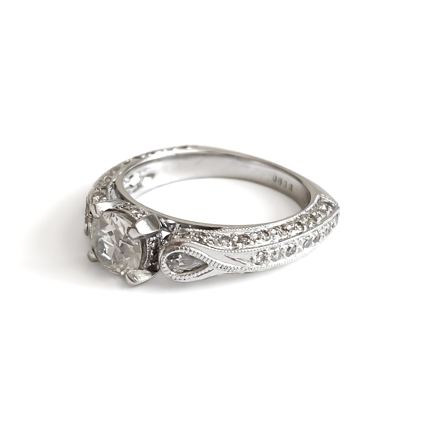 Glamorous 14ct white gold ring set with a 0.66ct centre diamond, a pear-shaped diamond on each shoulder and small pavé set diamonds on the shank. This is a lovely statement piece.  New York