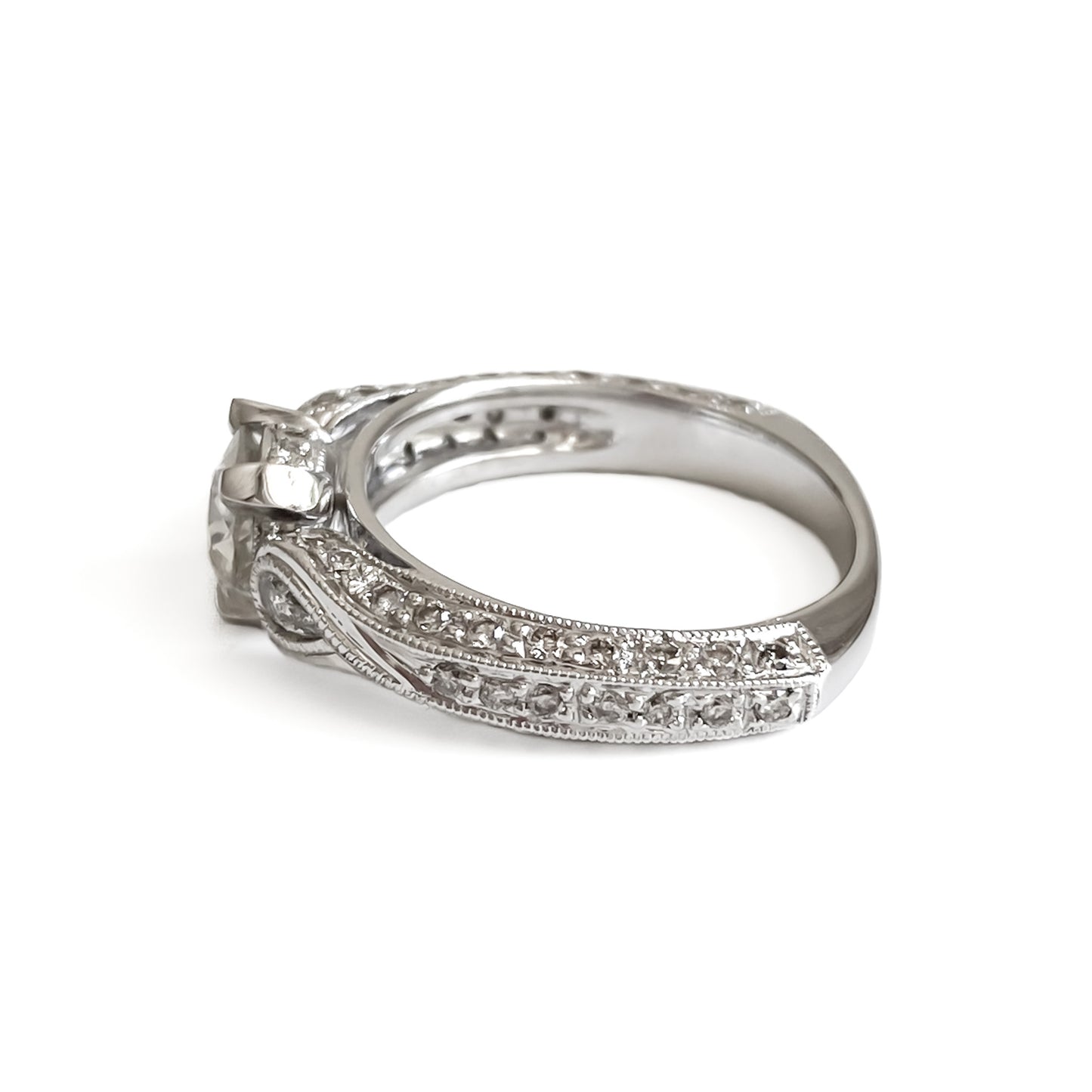 Glamorous 14ct white gold ring set with a 0.66ct centre diamond, a pear-shaped diamond on each shoulder and small pavé set diamonds on the shank. This is a lovely statement piece.  New York