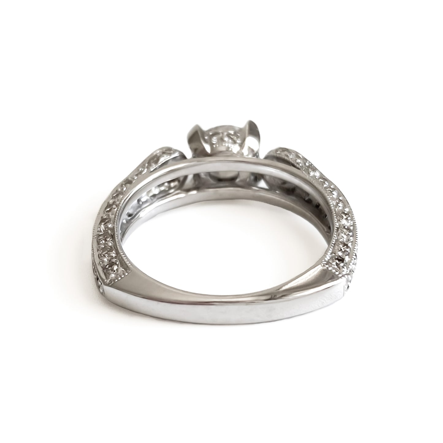 Glamorous 14ct white gold ring set with a 0.66ct centre diamond, a pear-shaped diamond on each shoulder and small pavé set diamonds on the shank. This is a lovely statement piece.  New York