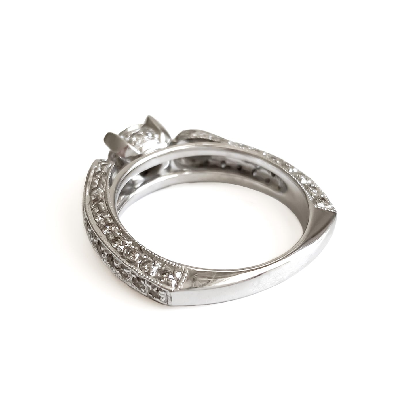 Glamorous 14ct white gold ring set with a 0.66ct centre diamond, a pear-shaped diamond on each shoulder and small pavé set diamonds on the shank. This is a lovely statement piece.  New York