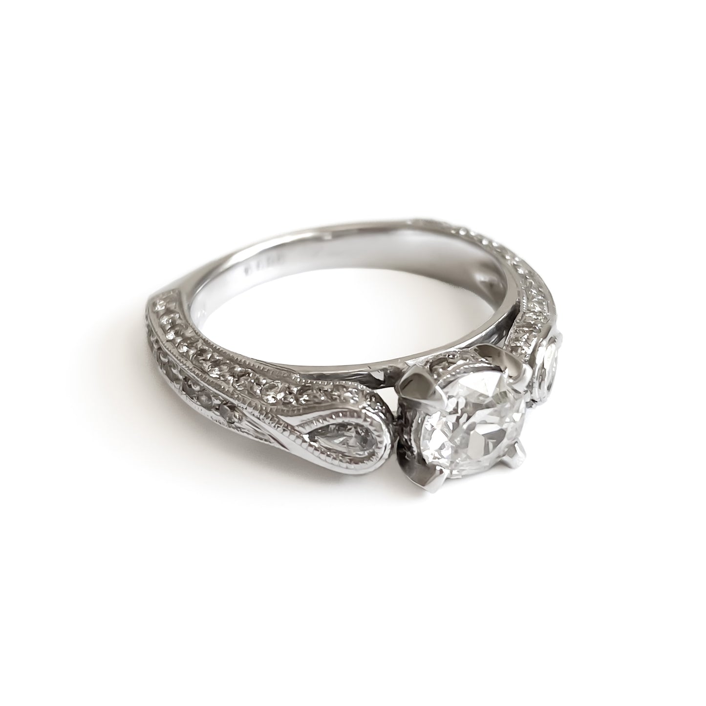 Glamorous 14ct white gold ring set with a 0.66ct centre diamond, a pear-shaped diamond on each shoulder and small pavé set diamonds on the shank. This is a lovely statement piece.  New York