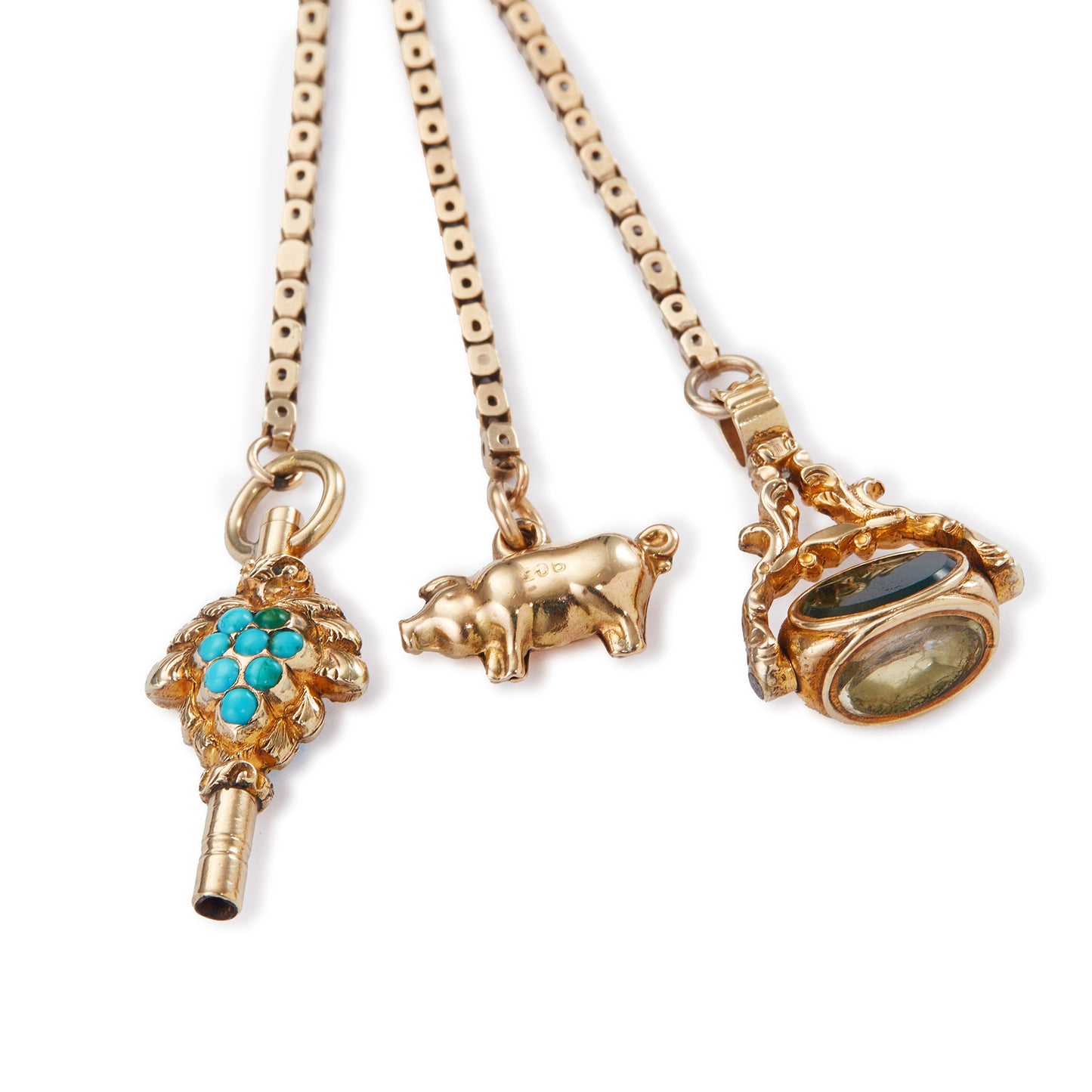 Highly sought after Victorian 15ct yellow gold attachment consisting of a dog clip, and three exquisite miniature pieces hanging from individual chains. The attachment consists of: a beautifully carved 15ct gold turquoise watch key, a 9ct gold pig charm and a 15ct gold swivel fob set with citrine, green agate and white chalcedony. Can be worn as a pendant or attached onto an Albertina.