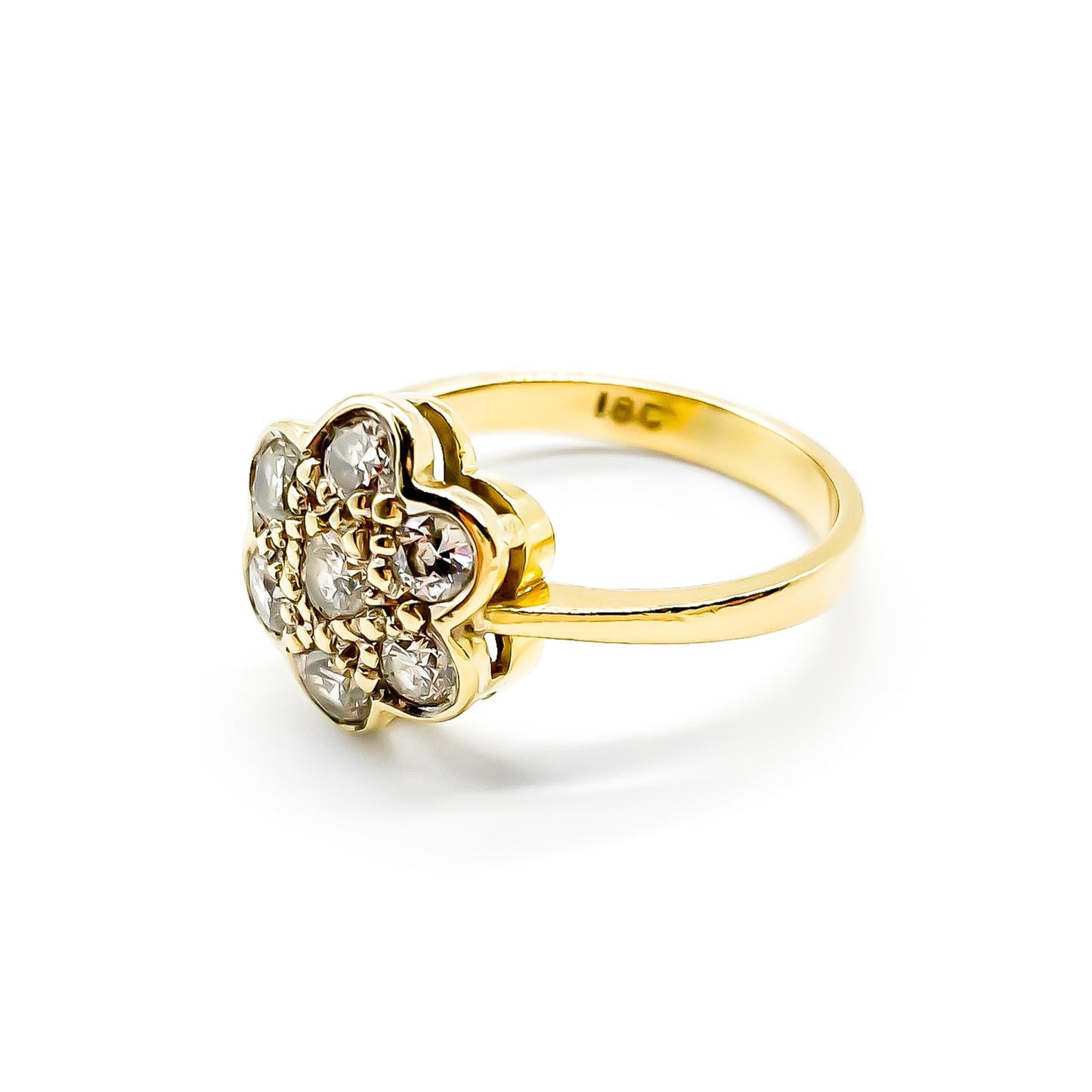 Lovely 18ct gold ring set with seven old-cut diamonds in the shape of a flower.