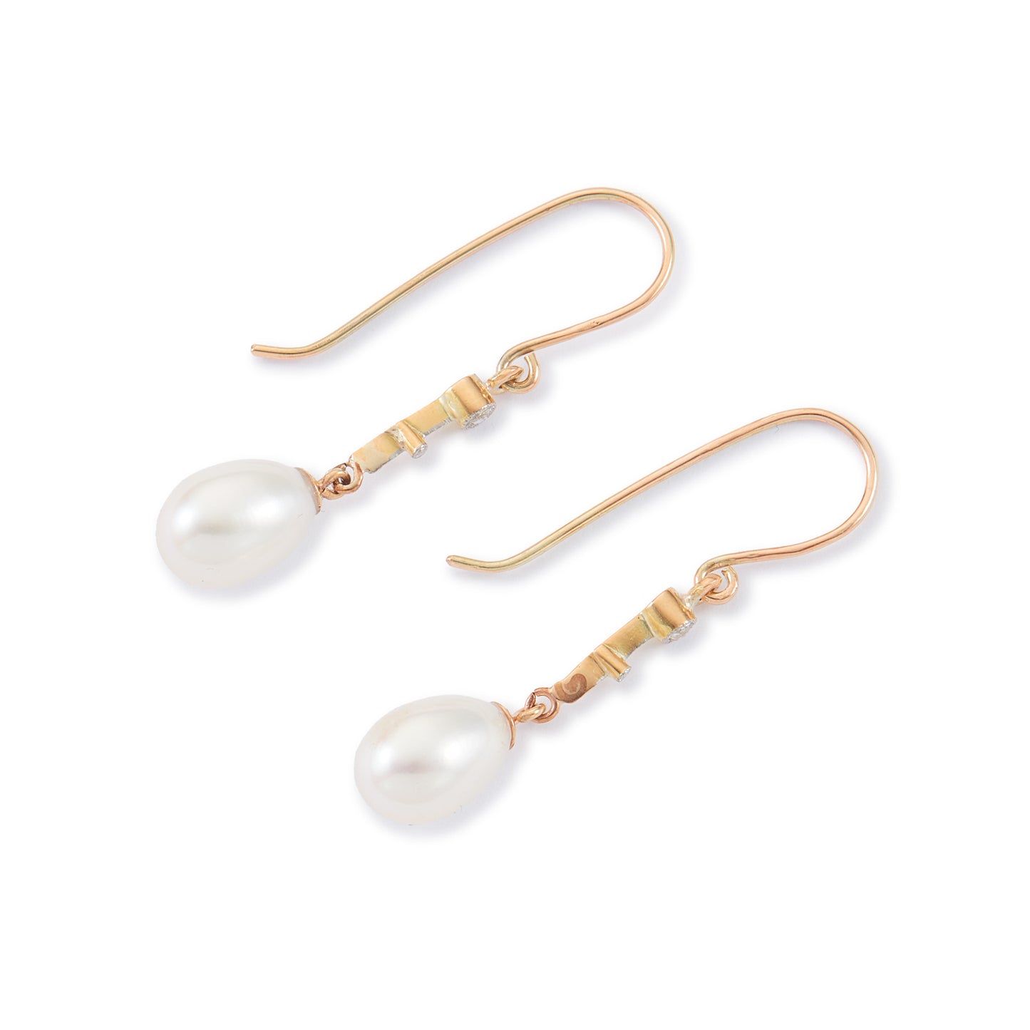 Delicate vintage 18ct gold dangling earrings, each set with a mine cut diamond and a lustrous pearl drop.