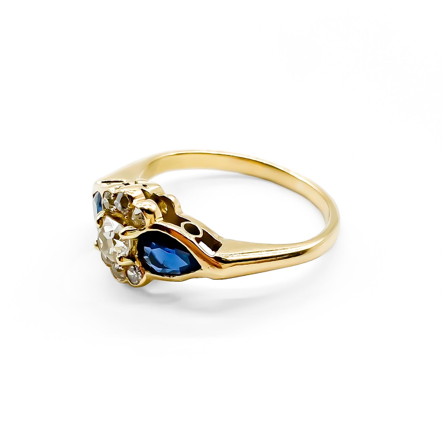 Classic 18ct gold ring set with seven diamonds and two pear-shaped sapphires.