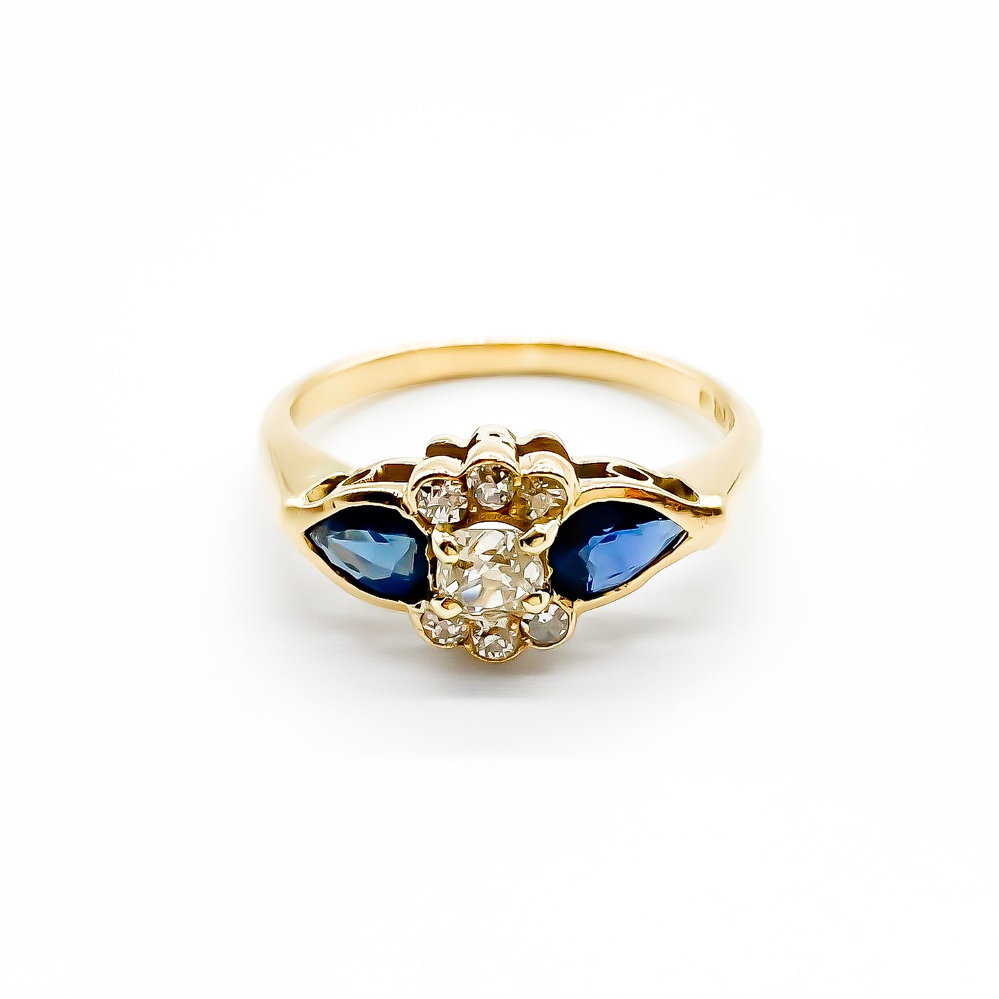 Classic 18ct gold ring set with seven diamonds and two pear-shaped sapphires.