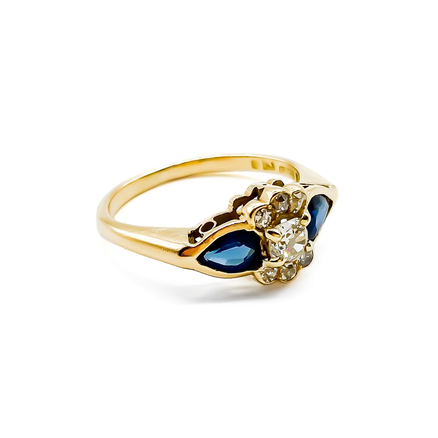 Classic 18ct gold ring set with seven diamonds and two pear-shaped sapphires.