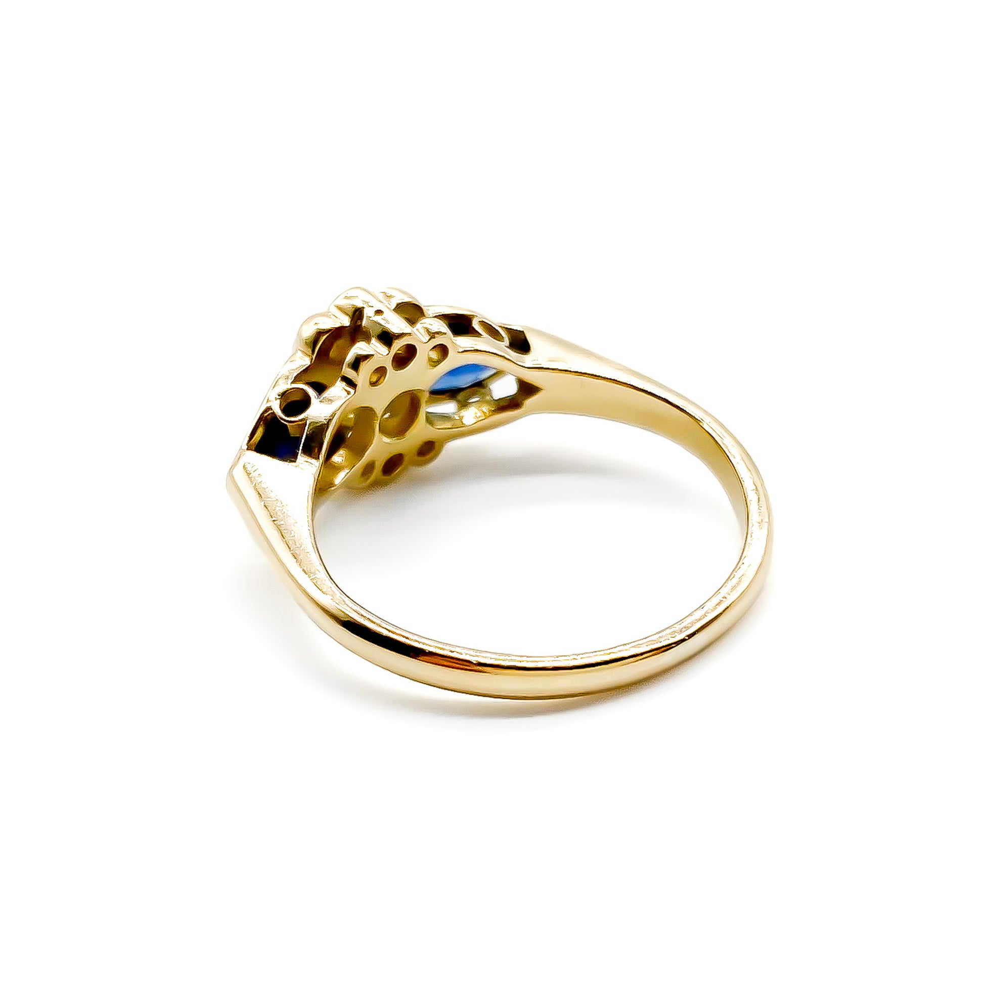 Classic 18ct gold ring set with seven diamonds and two pear-shaped sapphires.