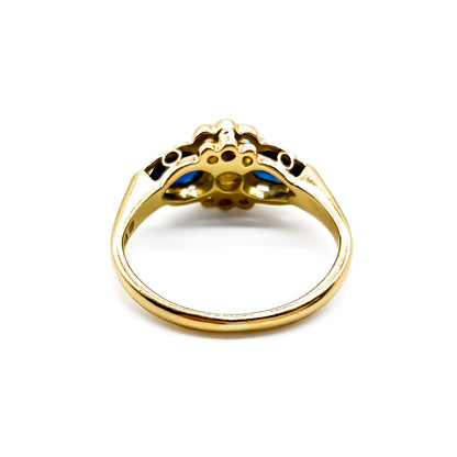 Classic 18ct gold ring set with seven diamonds and two pear-shaped sapphires.