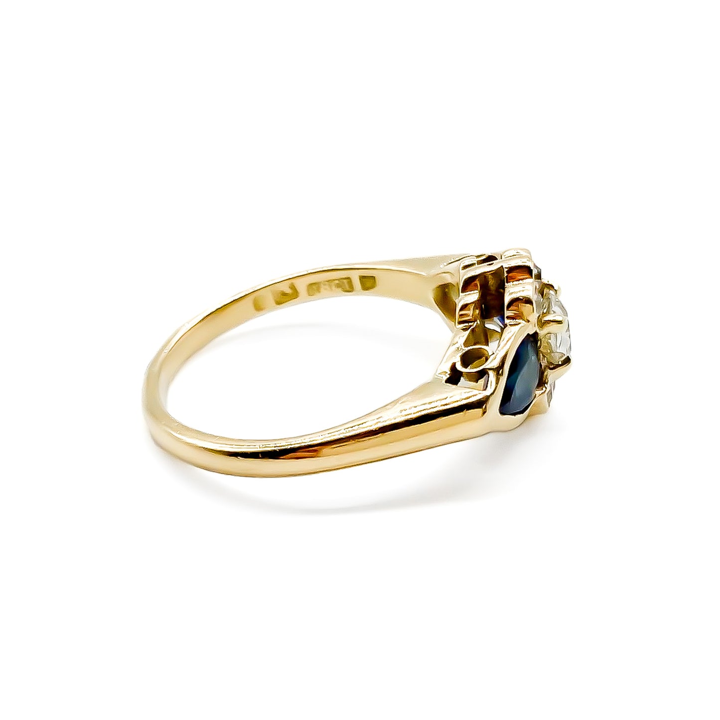 Classic 18ct gold ring set with seven diamonds and two pear-shaped sapphires.