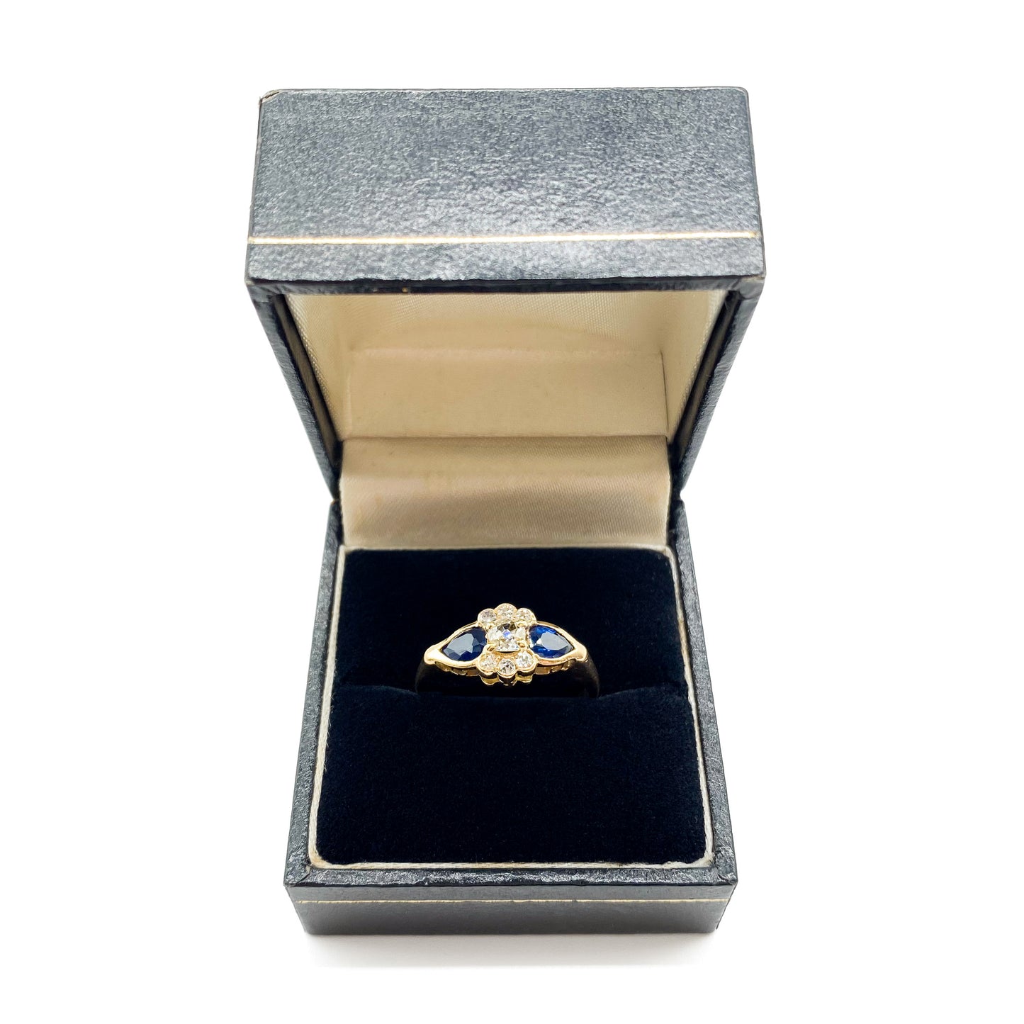 Classic 18ct gold ring set with seven diamonds and two pear-shaped sapphires.