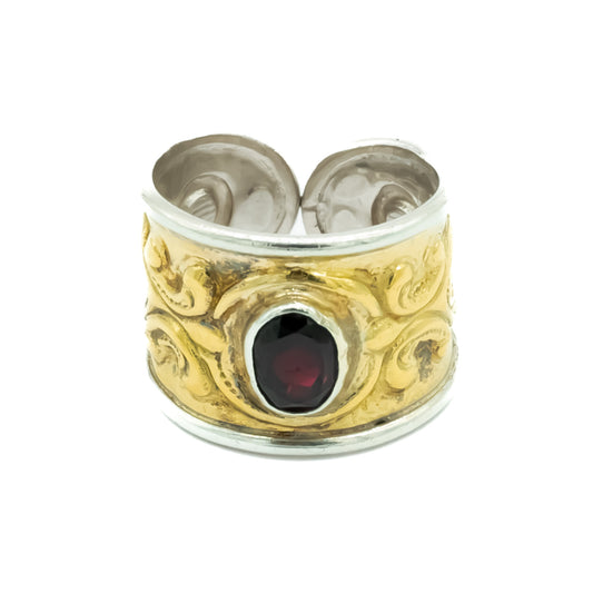 Gorgeous vintage 18ct yellow gold on silver repoussé band set with a deep red oval faceted garnet. Italy