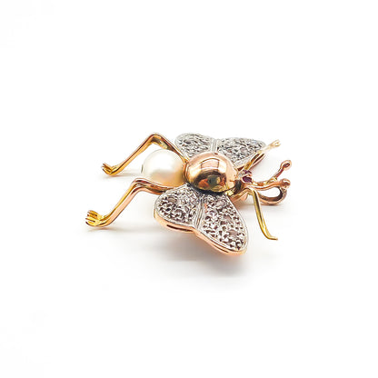 Exquisite 18ct rose gold insect pendant with white gold diamond encrusted wings, ruby eyes and a pearl body. Circa 1940’s