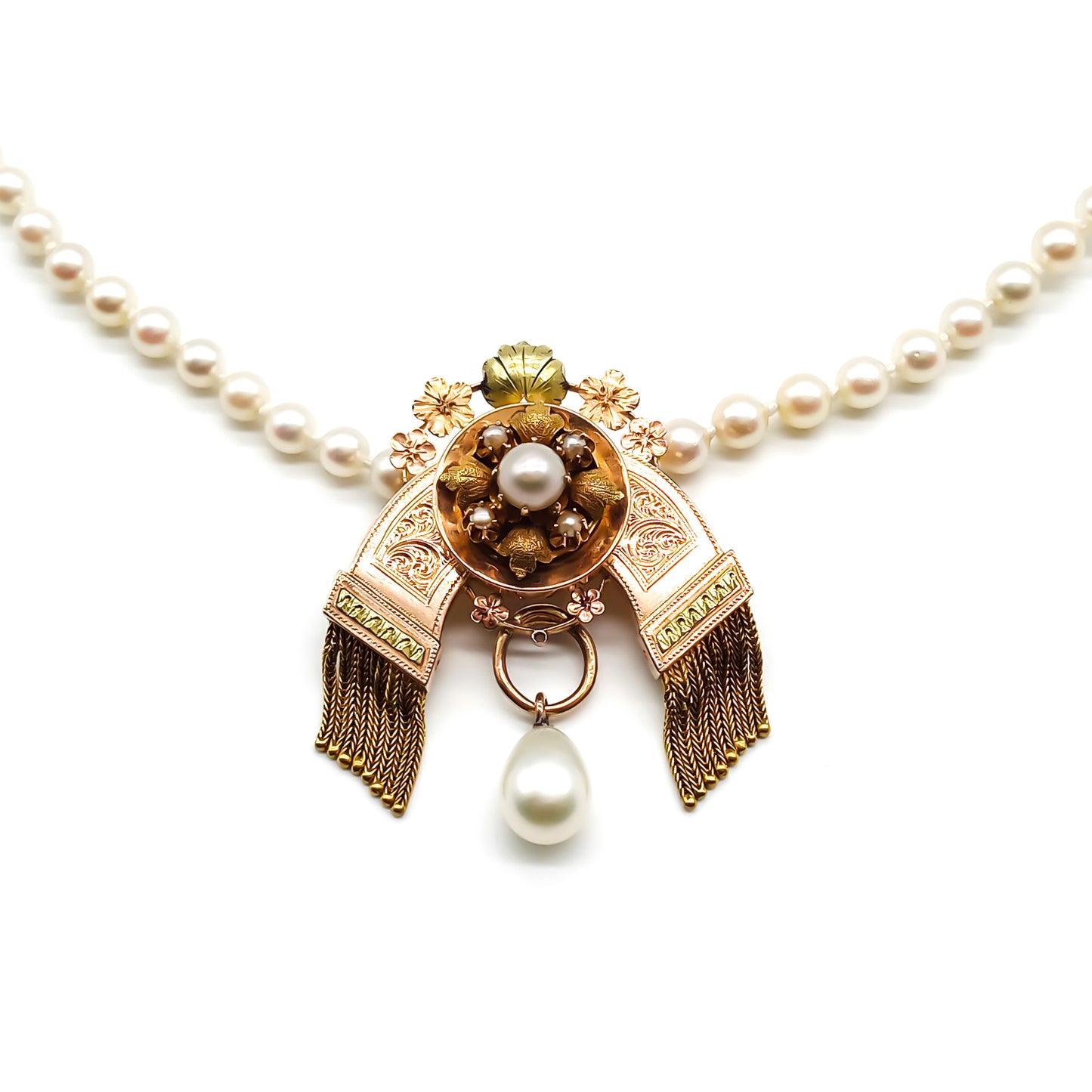 Very ornate Victorian rose and yellow gold tassel pendant with a pearl drop, fastened onto a string of small lustrous pearls with a gold clasp.
