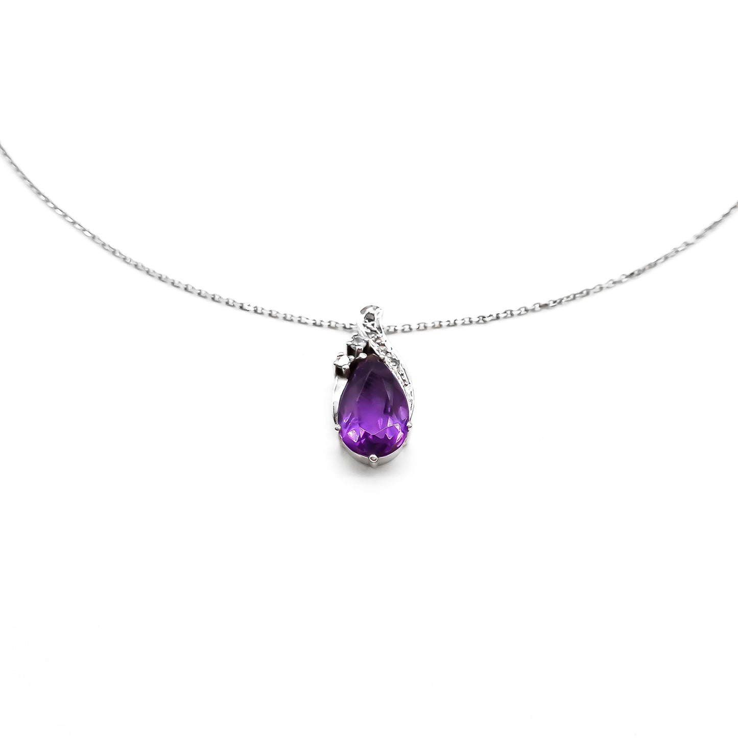 Dainty 18ct white gold diamond pendant set with a deep purple pear-cut amethyst on an 18ct white gold chain.