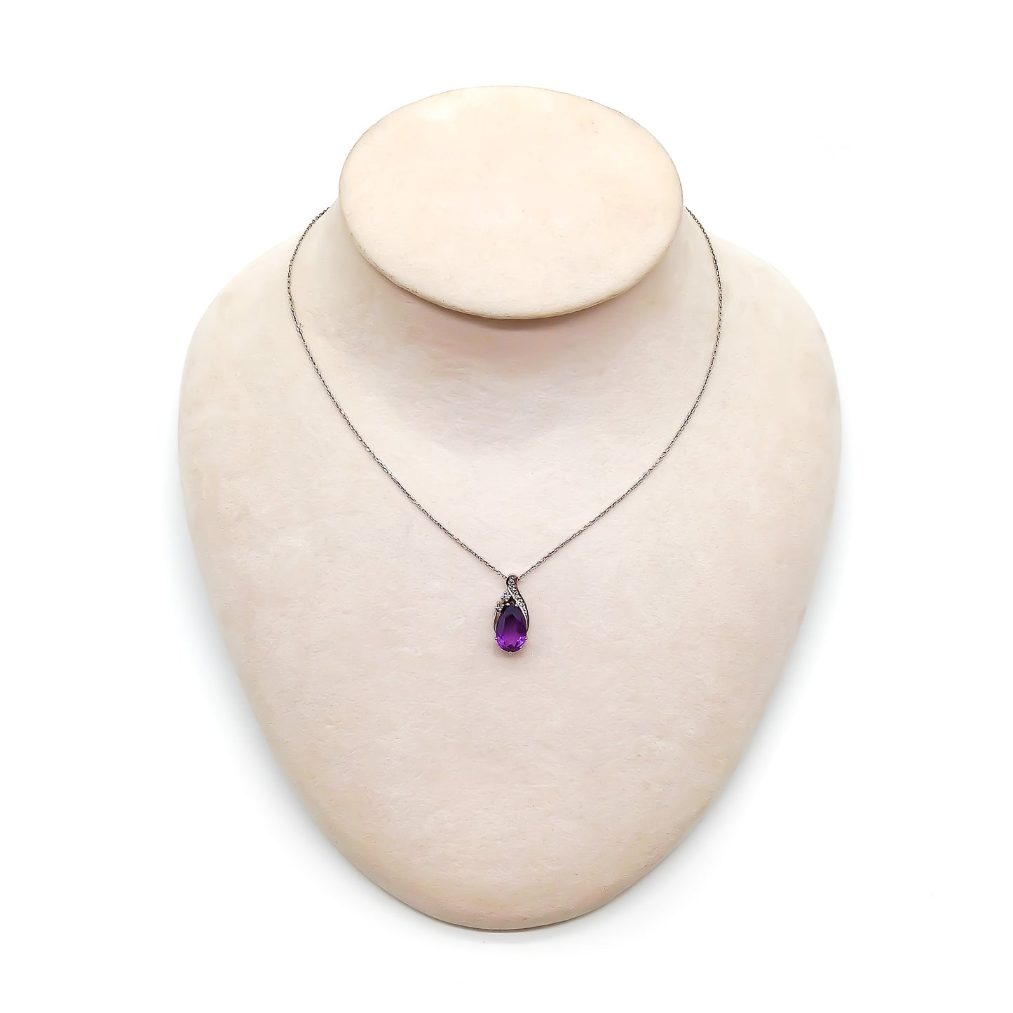 Dainty 18ct white gold diamond pendant set with a deep purple pear-cut amethyst on an 18ct white gold chain.