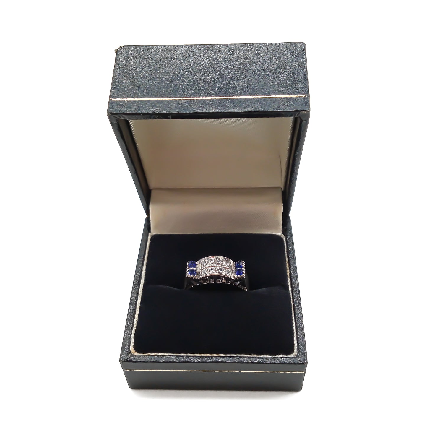 Stylish 18ct white gold ring set with four rectangular sapphires and eight round diamonds.