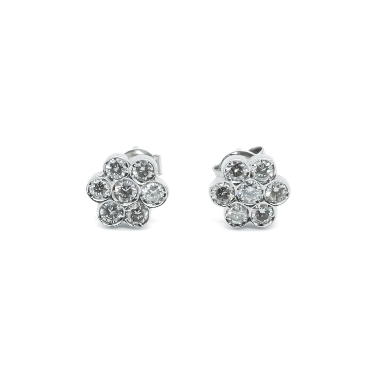 Classic 18ct white gold flower shaped stud earrings, each set with seven diamonds.