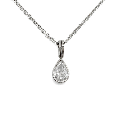 Stylish 18ct white gold necklace set with a 0.85ct pear-shaped centre diamond drop and four beads encrusted with small diamonds.
