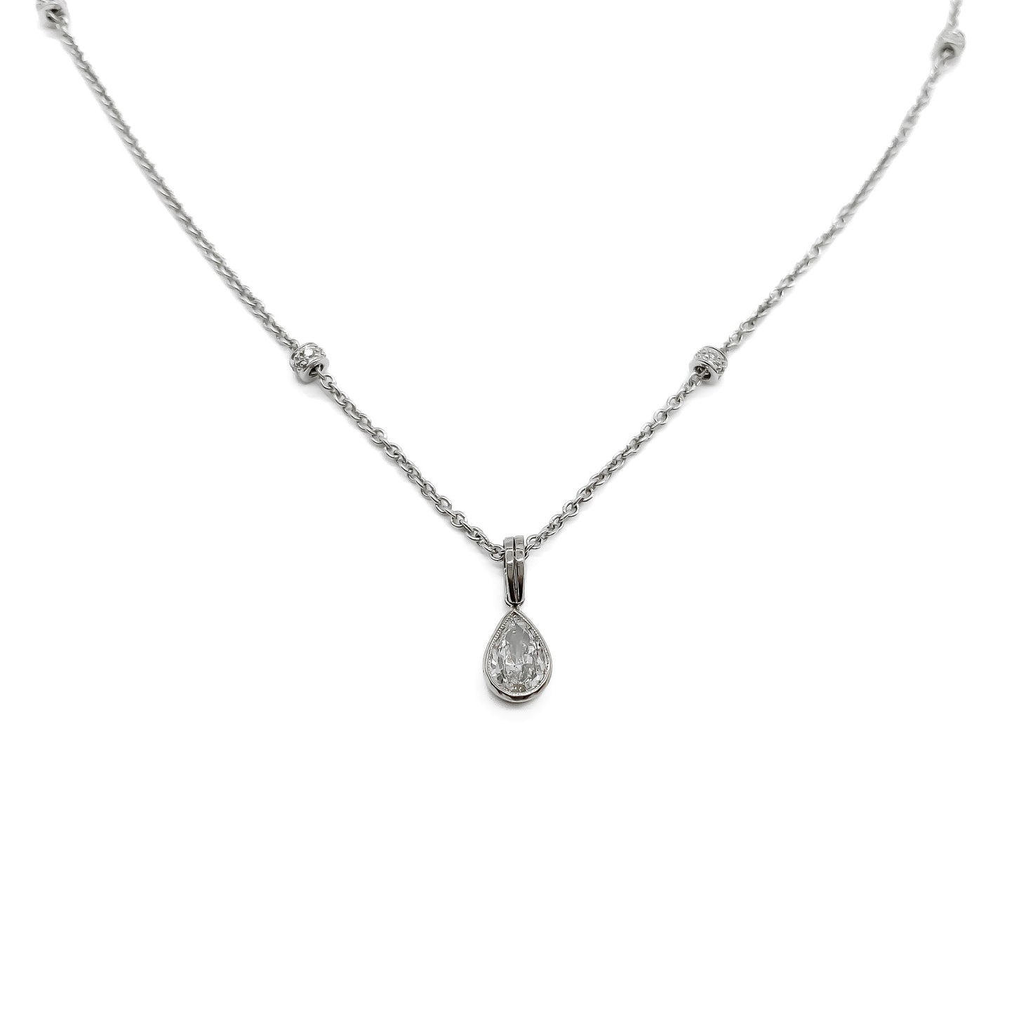 Stylish 18ct white gold necklace set with a 0.85ct pear-shaped centre diamond drop and four beads encrusted with small diamonds.