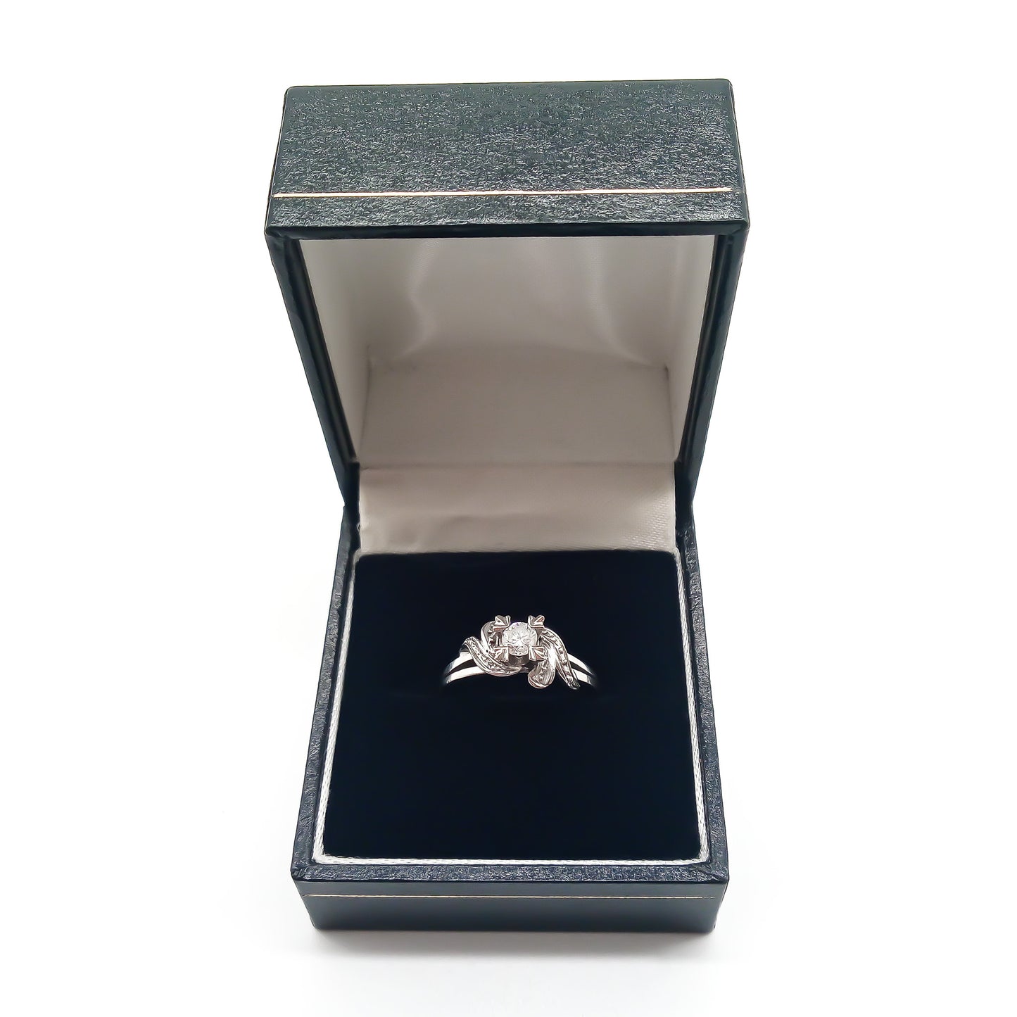Classic 18ct white gold solitaire diamond ring with lovely flourish detail.