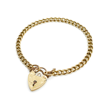 Classic 9ct yellow gold curb link bracelet with padlock. Safety chain attached. Circa 1940's