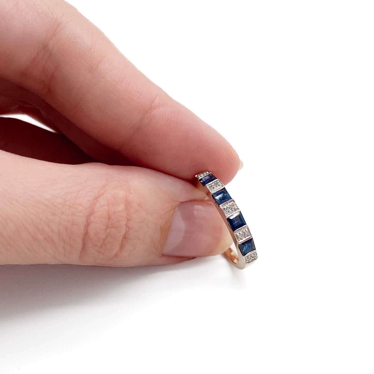 Classic vintage 9ct gold half eternity ring set with ten tiny diamonds and four natural, square sapphires. 
