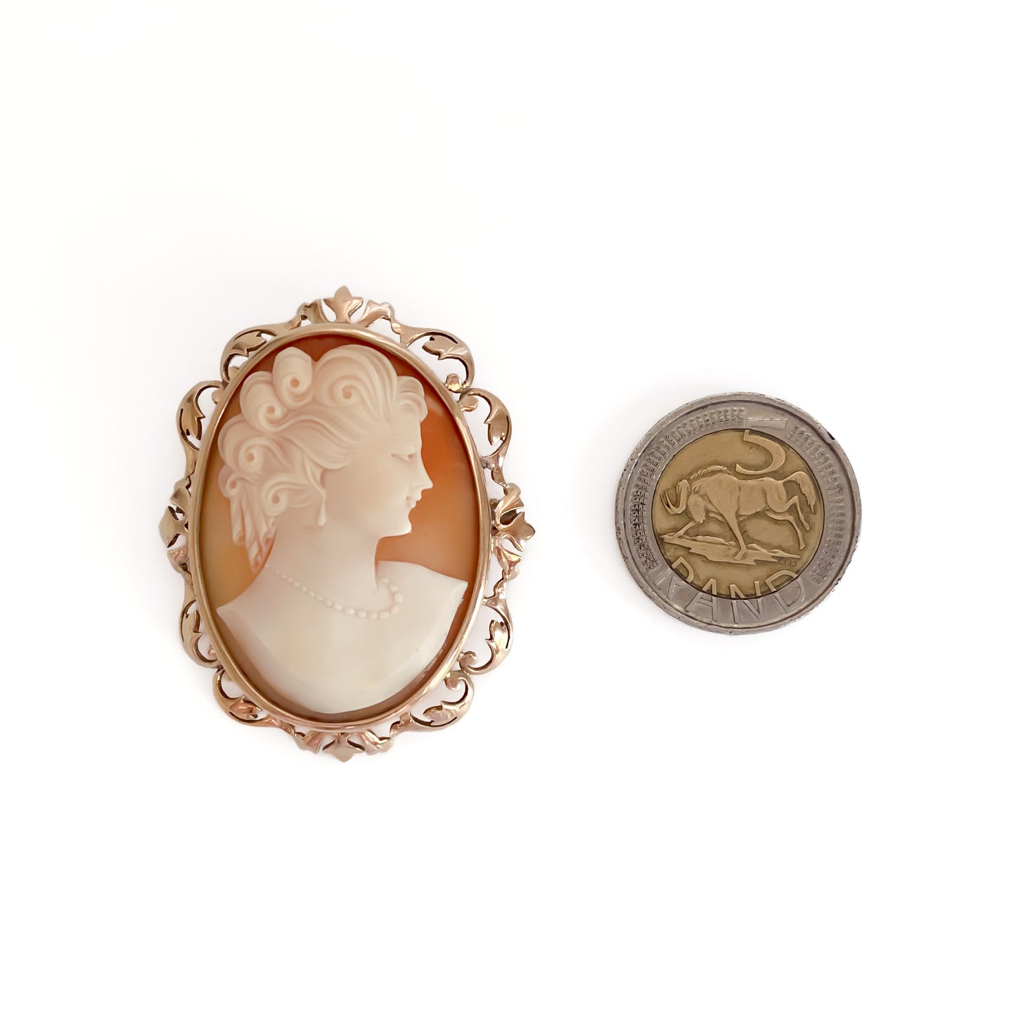 Beautifully carved cameo set in an ornate 9ct rose gold frame. Can be worn as a brooch or a pendant.