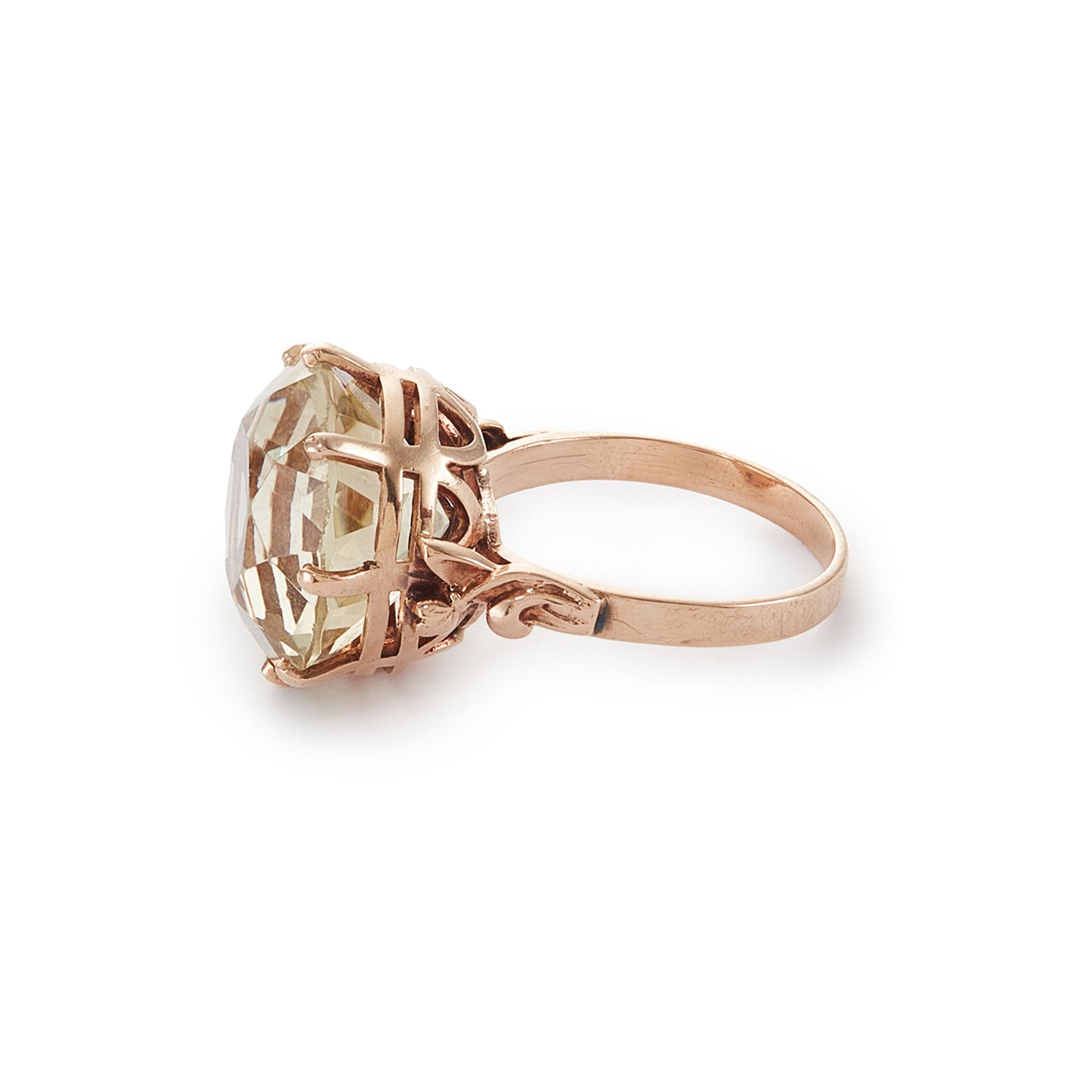 Stylish 9ct gold ring set with a light coloured citrine in an elevated claw setting. Ornate flower detail on the shoulders.