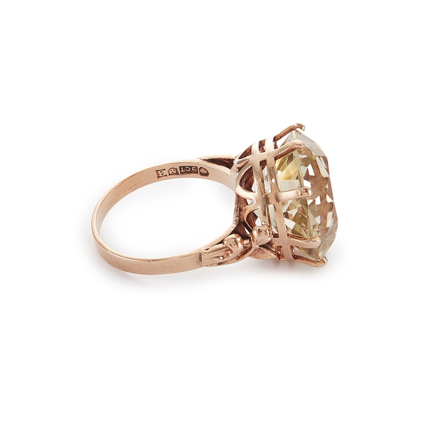 Stylish 9ct gold ring set with a light coloured citrine in an elevated claw setting. Ornate flower detail on the shoulders.