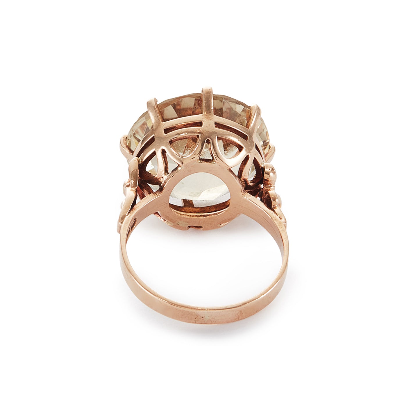 Stylish 9ct gold ring set with a light coloured citrine in an elevated claw setting. Ornate flower detail on the shoulders.