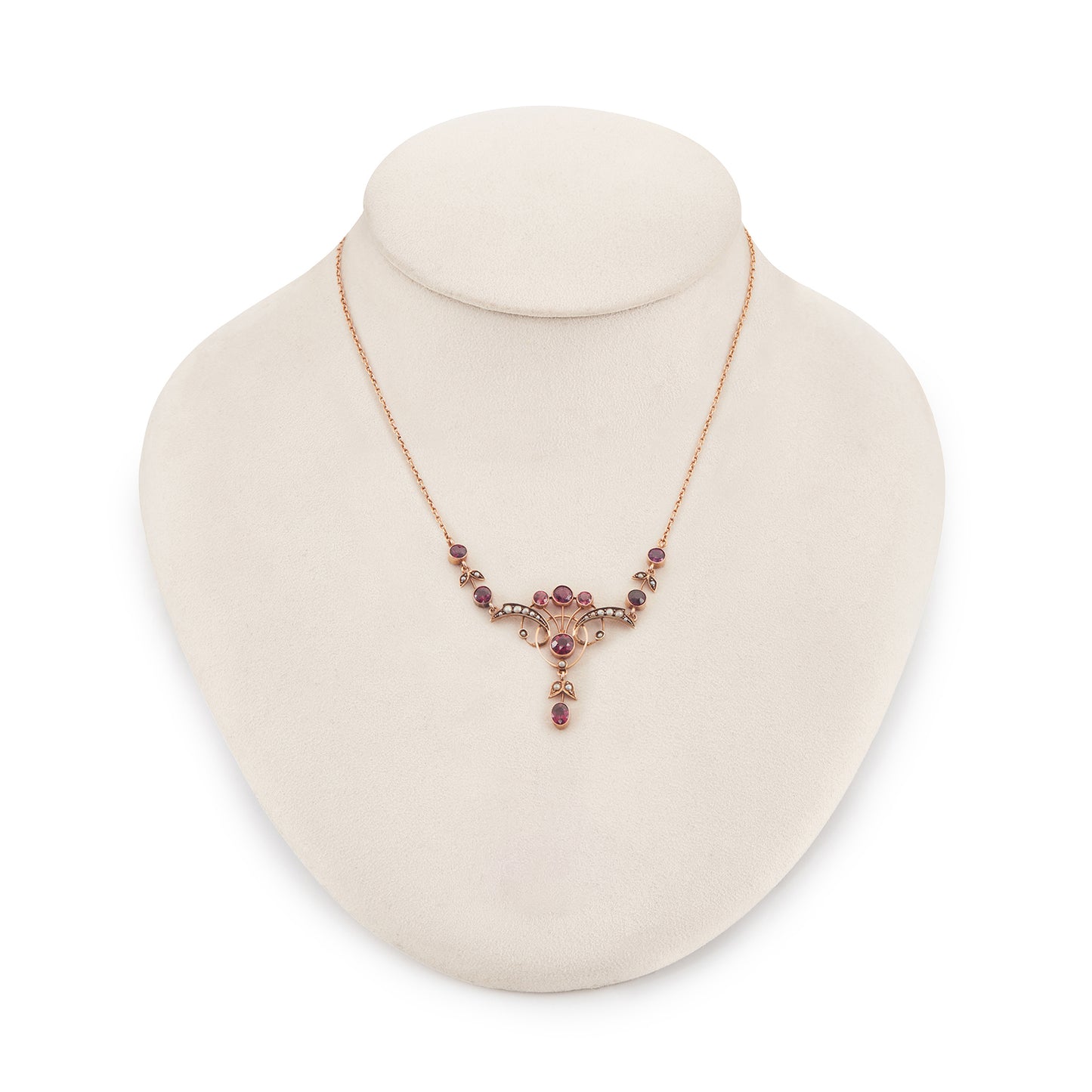 Exquisite Edwardian 9ct rose gold necklace set with nine rhodolite garnets and eighteen seed pearls.