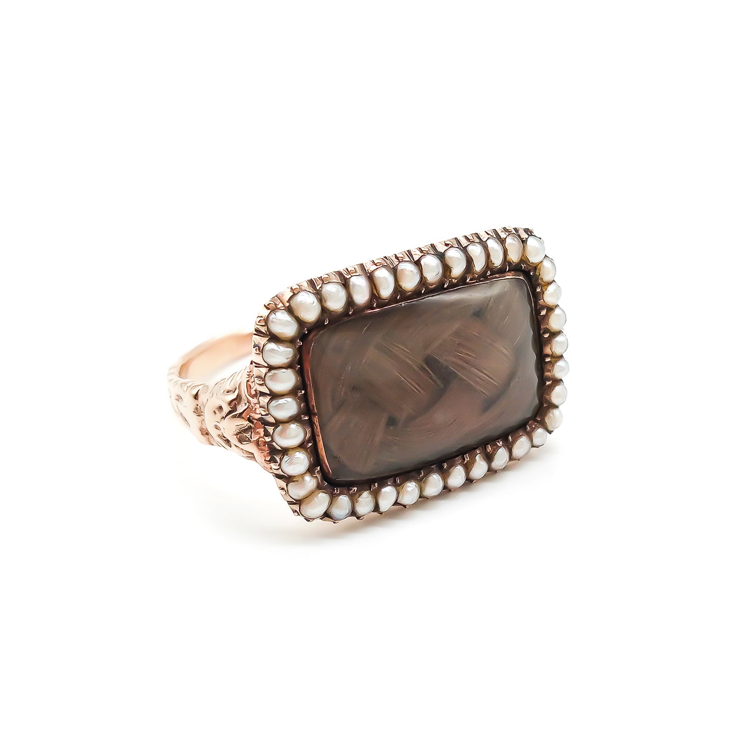 Beautifully crafted Georgian mourning ring in a 9ct rose gold setting with plaited hair under domed glass, adorned with tiny seed pearls. Later shank.