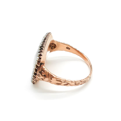 Beautifully crafted Georgian mourning ring in a 9ct rose gold setting with plaited hair under domed glass, adorned with tiny seed pearls. Later shank.