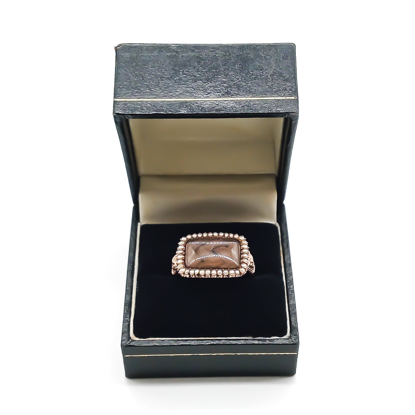 Beautifully crafted Georgian mourning ring in a 9ct rose gold setting with plaited hair under domed glass, adorned with tiny seed pearls. Later shank.