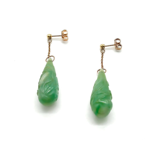 Sought-after 9ct rose gold dangling earrings, each set with a beautifully carved pear-shaped jade drop. Circa 1940’s