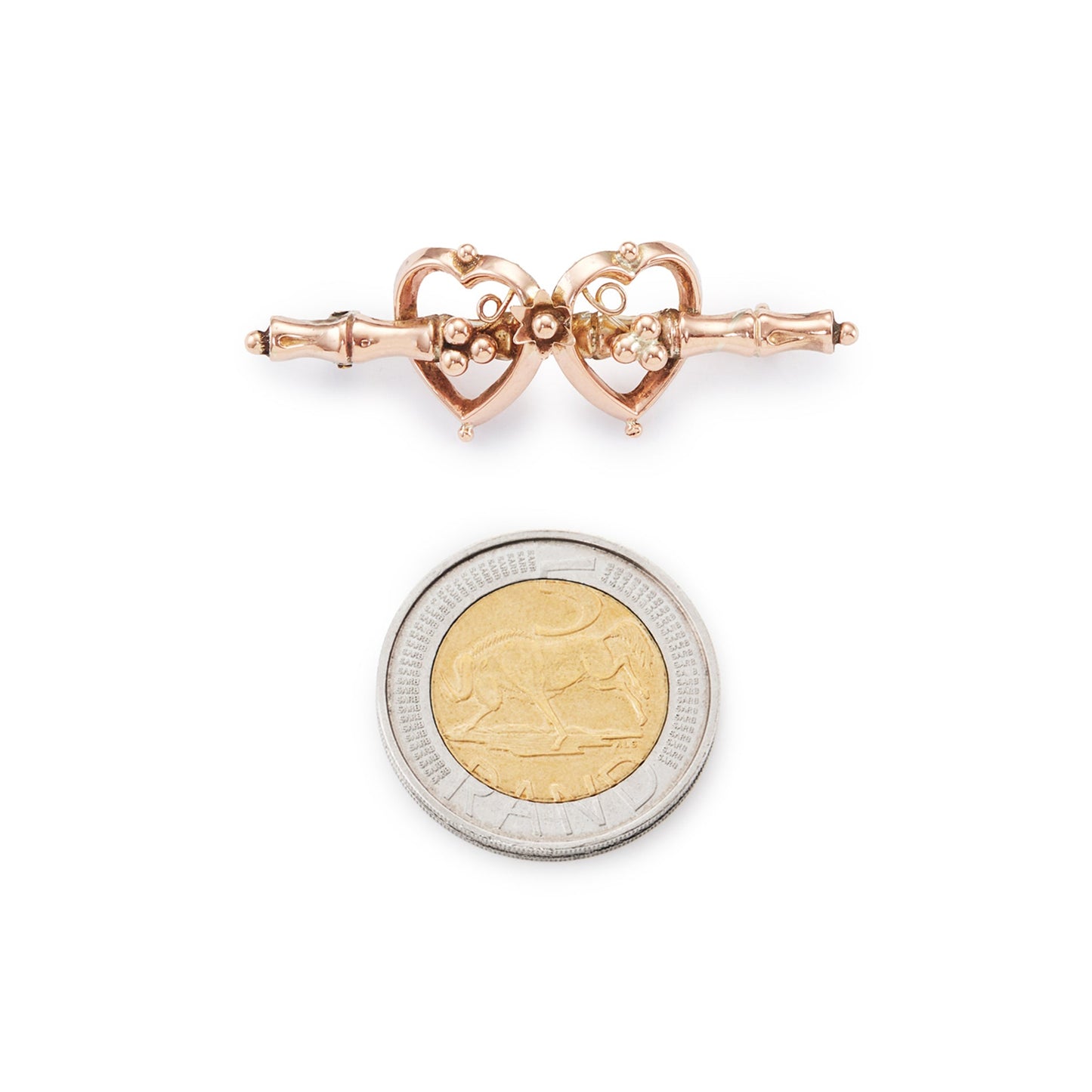 Pretty Victorian 9ct rose gold brooch depicting two hearts with floral details.