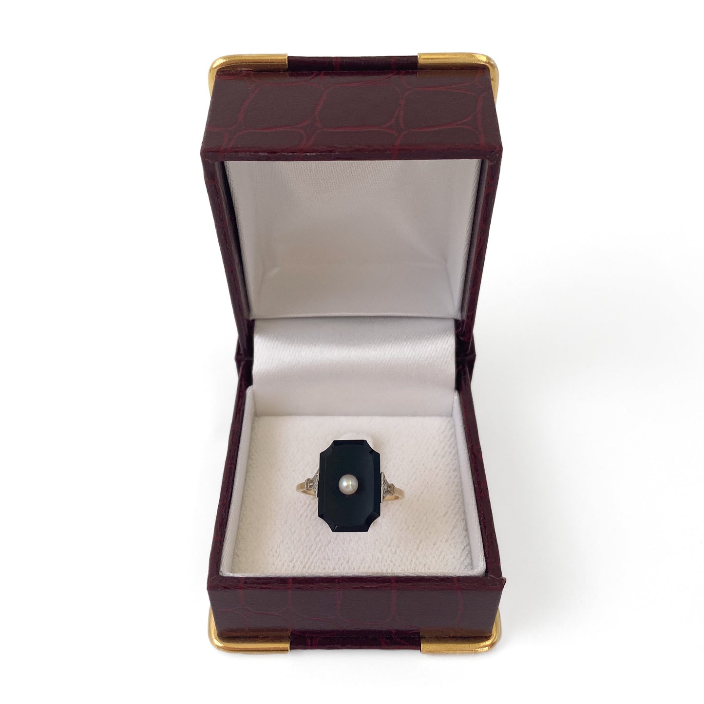 Stylish 18ct gold Art Deco onyx ring set with a single seed pearl and a mine cut diamond on each shoulder.