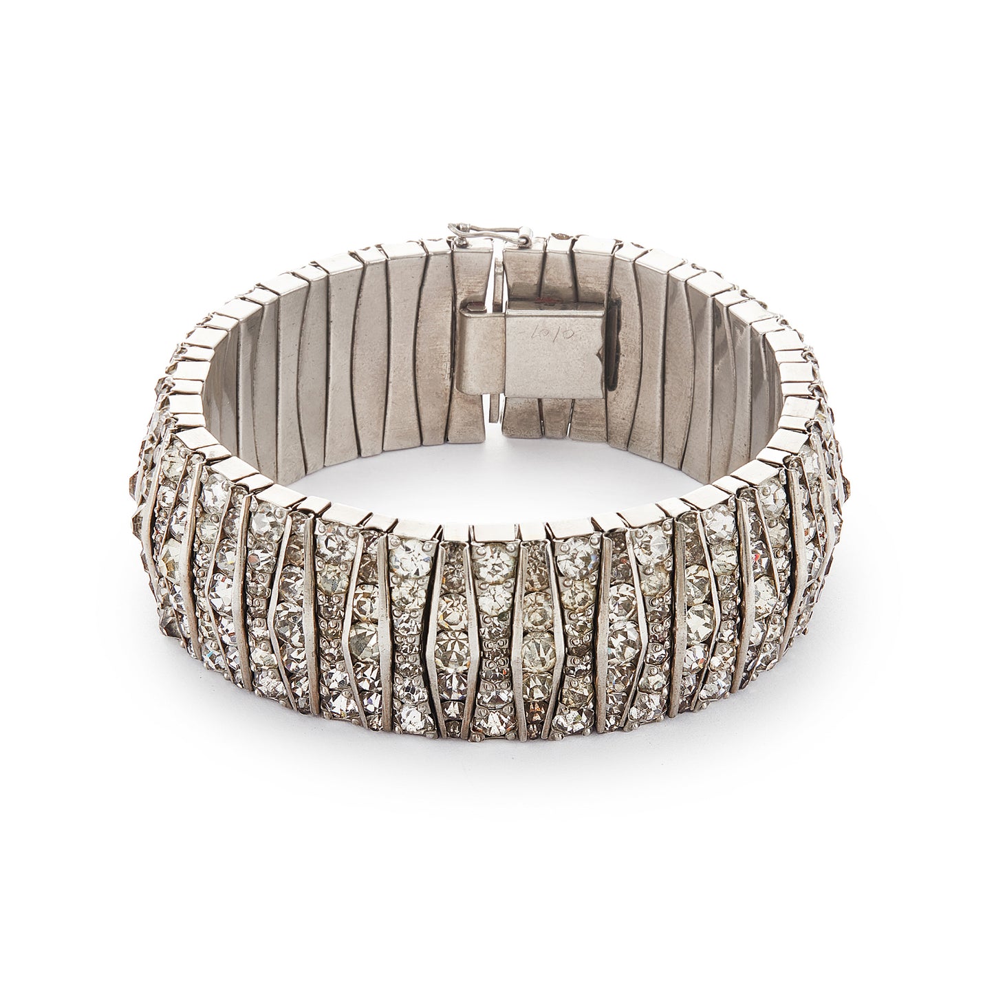 Glamorous articulated Art Deco metal bracelet set with an abundance of paste stones in varying shades of white.