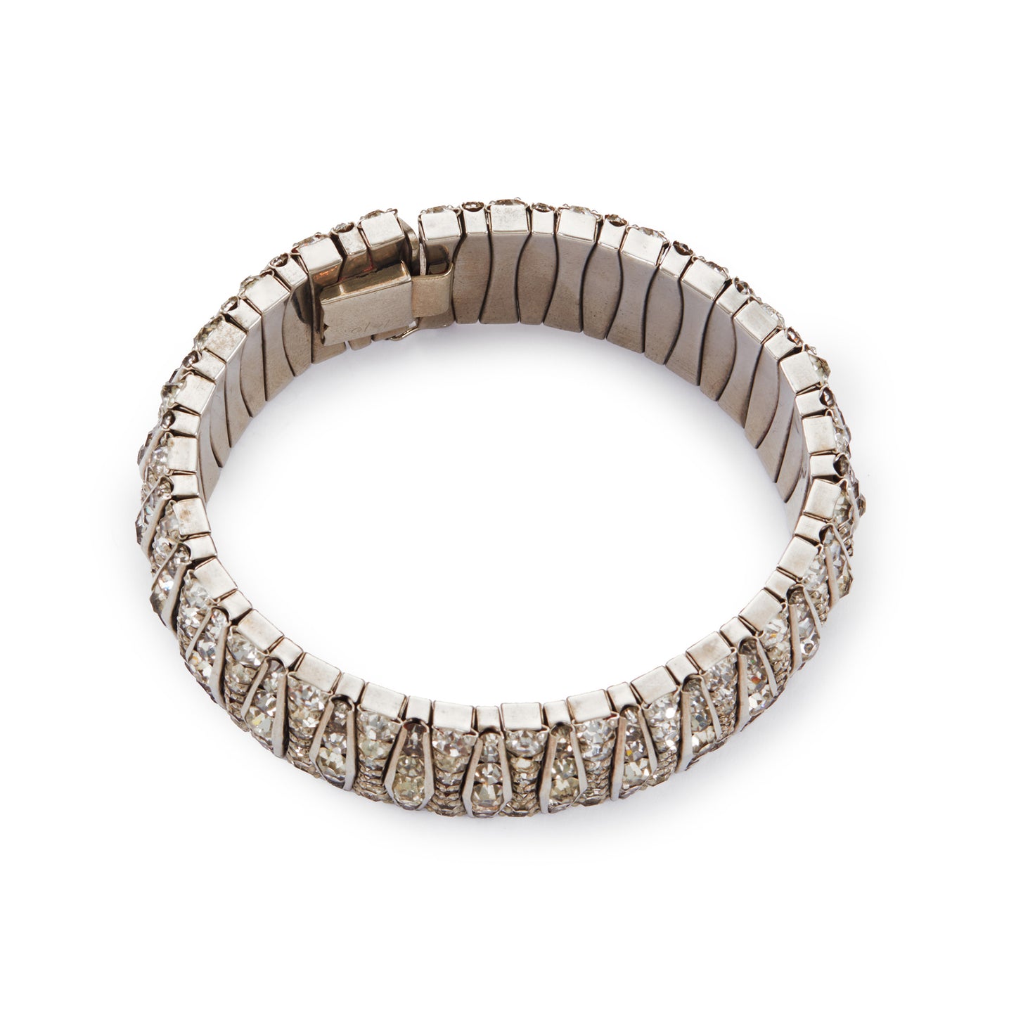 Glamorous articulated Art Deco metal bracelet set with an abundance of paste stones in varying shades of white.
