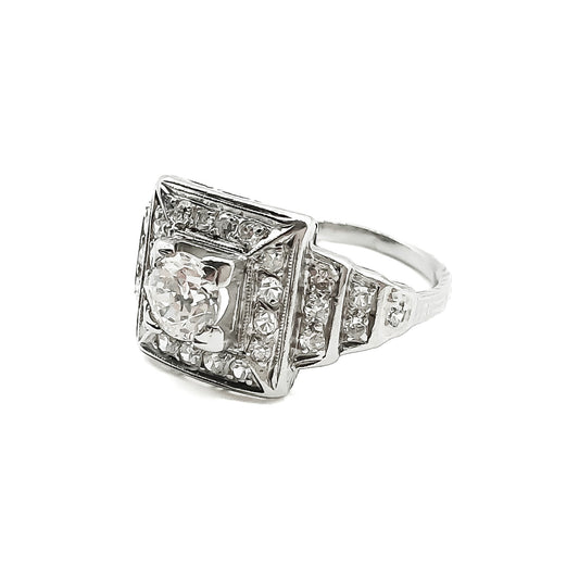 Stylish Art Deco platinum diamond ring set with a 0.50ct centre diamond, surrounded by twenty-eight smaller old-cut diamonds.