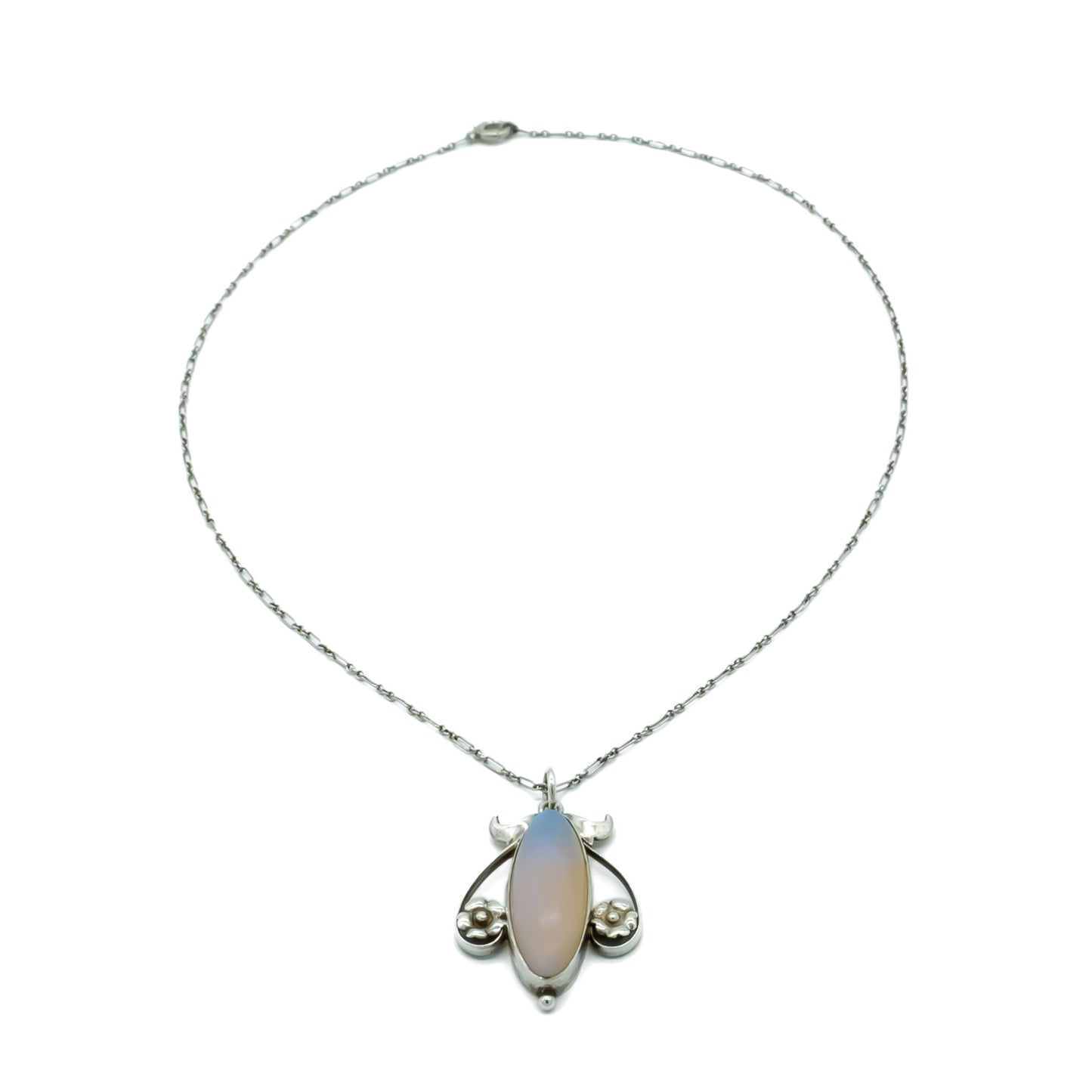 Exquisite silver Art Nouveau pendant set with a luminescent oval moonstone on a delicate fancy link chain.