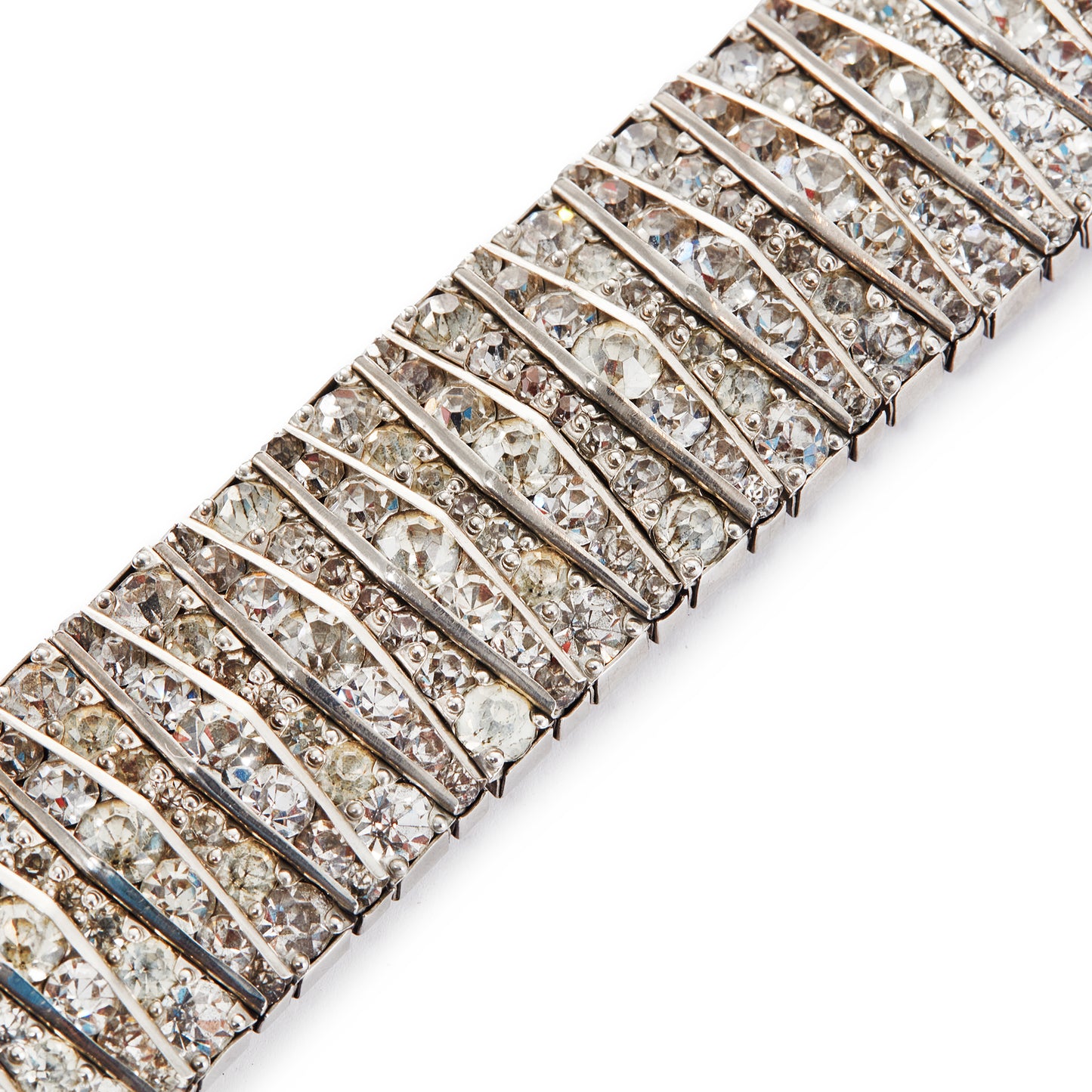 Glamorous articulated Art Deco metal bracelet set with an abundance of paste stones in varying shades of white.