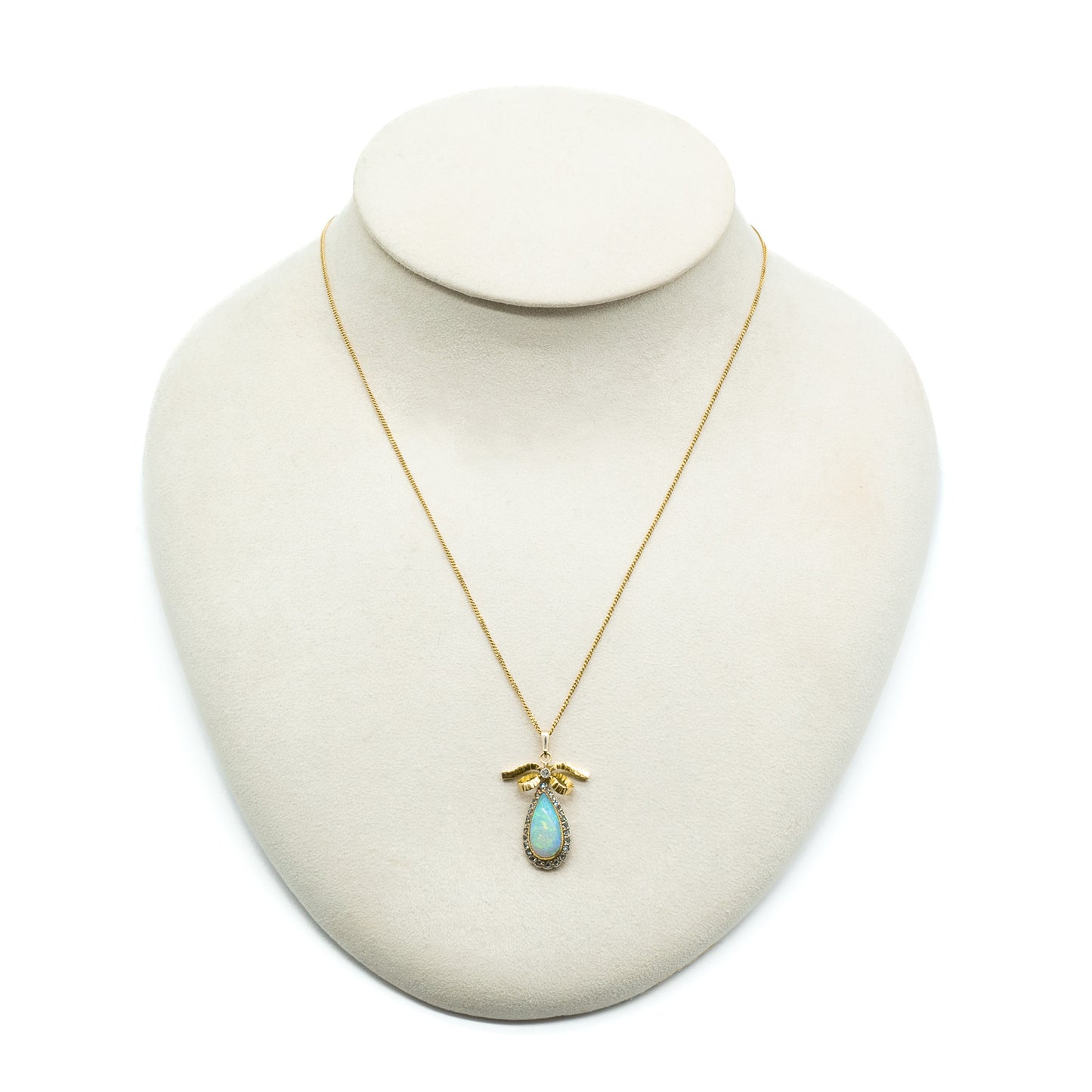 Exquisite 18ct yellow gold pendant set with a luminous opal surrounded by old-cut diamonds on an 18ct gold chain.